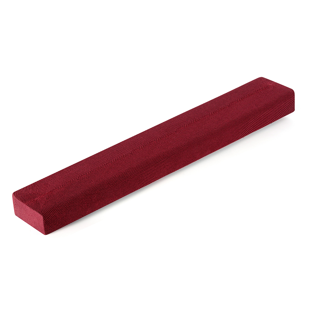 Un coussin rectangulaire tricoté marron est présenté en biais sur un fond blanc.