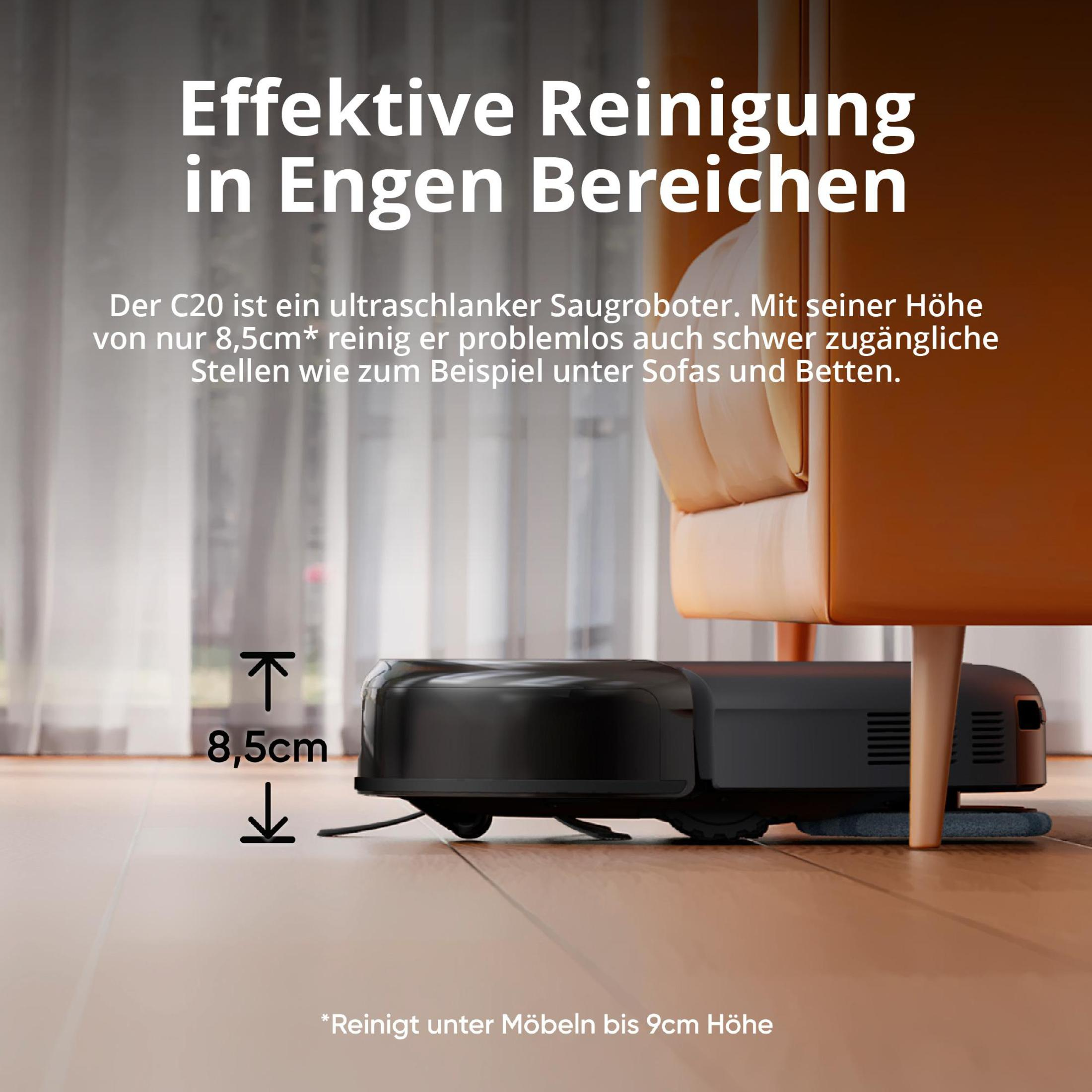 Czarny odkurzacz automatyczny sprząta pod jasno brązową kanapą na drewnianej podłodze.