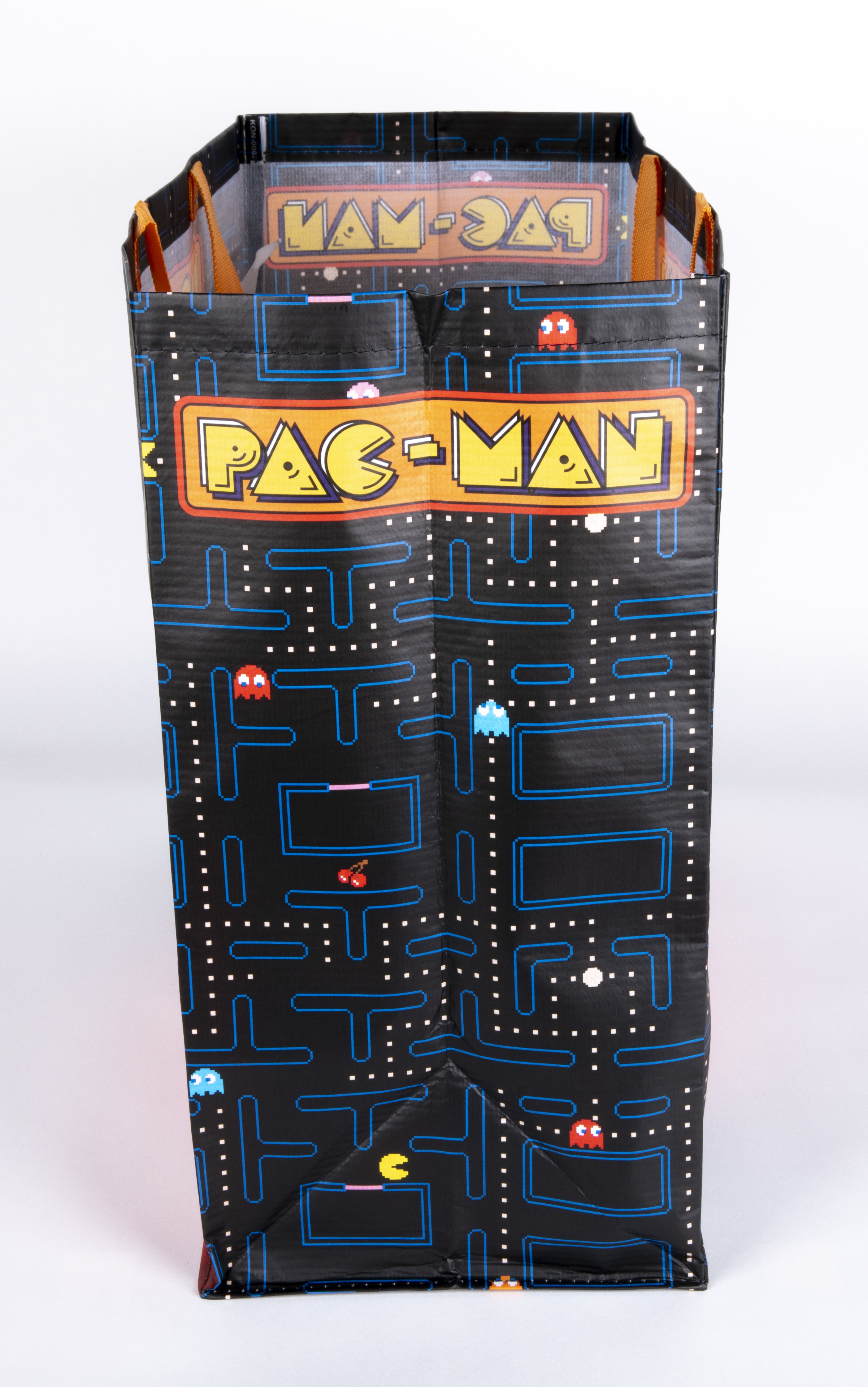 Eine schwarze Pac-Man-Einkaufstasche mit dem Pac-Man-Labyrinth-Design und dem Pac-Man-Logo darauf.