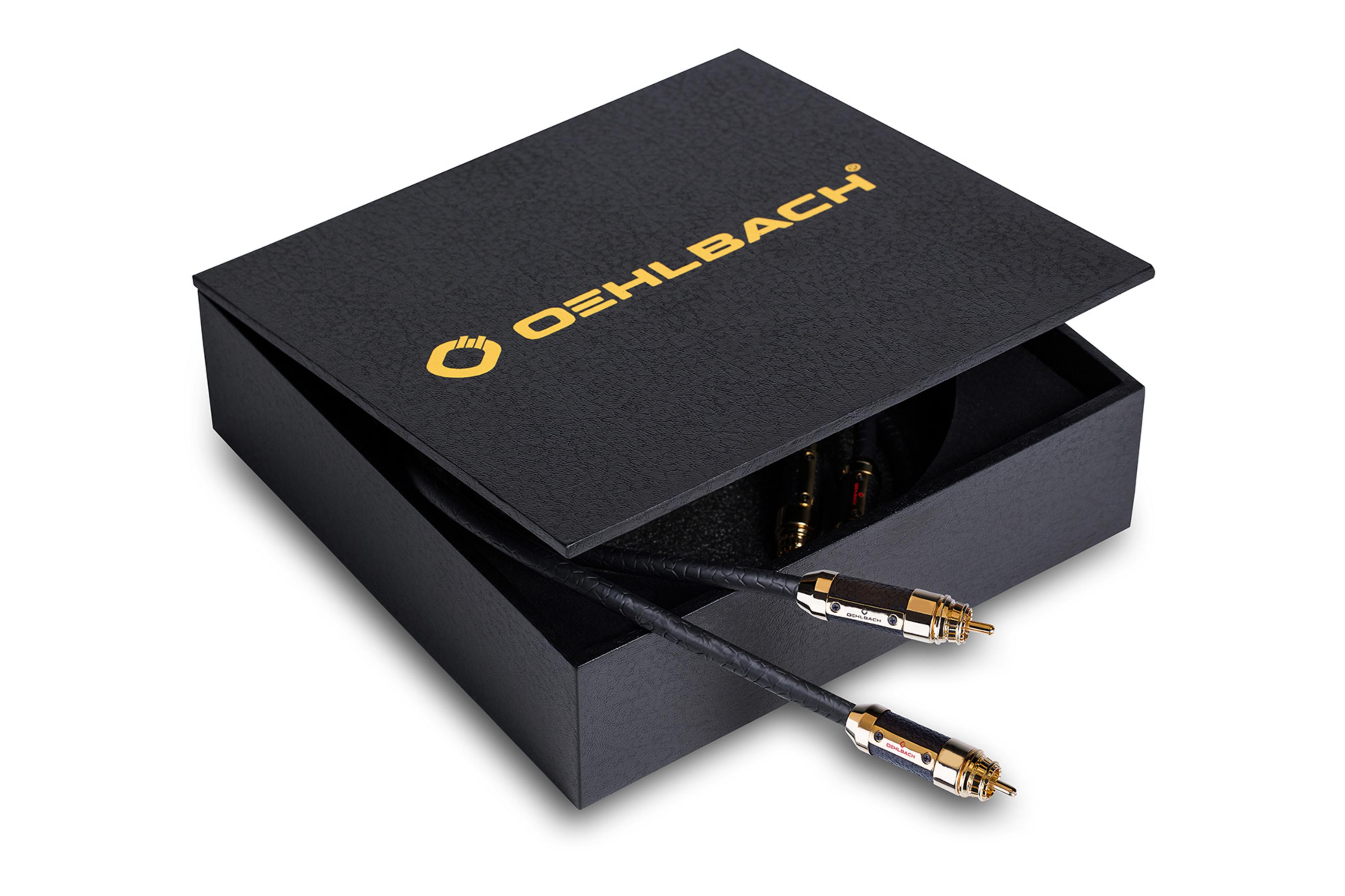 Schwarze Box mit goldenem Logo. Kabel und Stecker. 'OEHLBACH' Logo auf der Box.