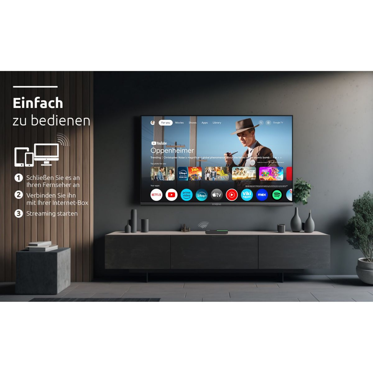 Salón con un televisor que muestra una interfaz de aplicaciones de streaming. Un mueble negro y un cubo gris.