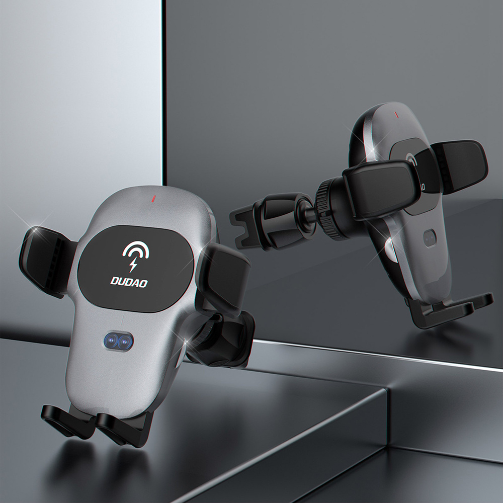 Dwa szare uchwyty samochodowe na telefon z logo DUDAD. Jeden jest przymocowany do klipsa wentylacyjnego.
