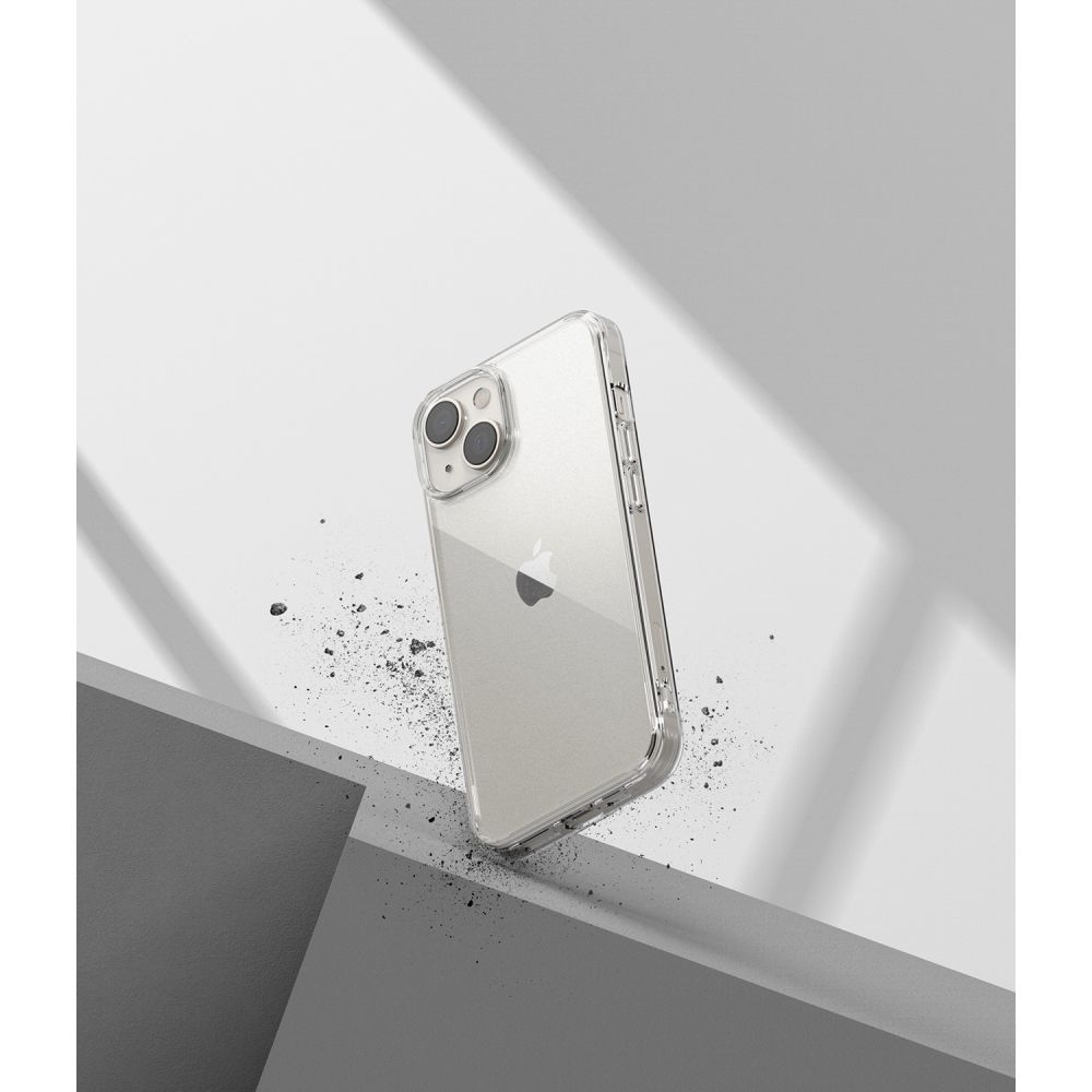 iPhone w przezroczystym etui spada. Etui leży na pochylonej powierzchni. Szare/białe gradientowe tło.