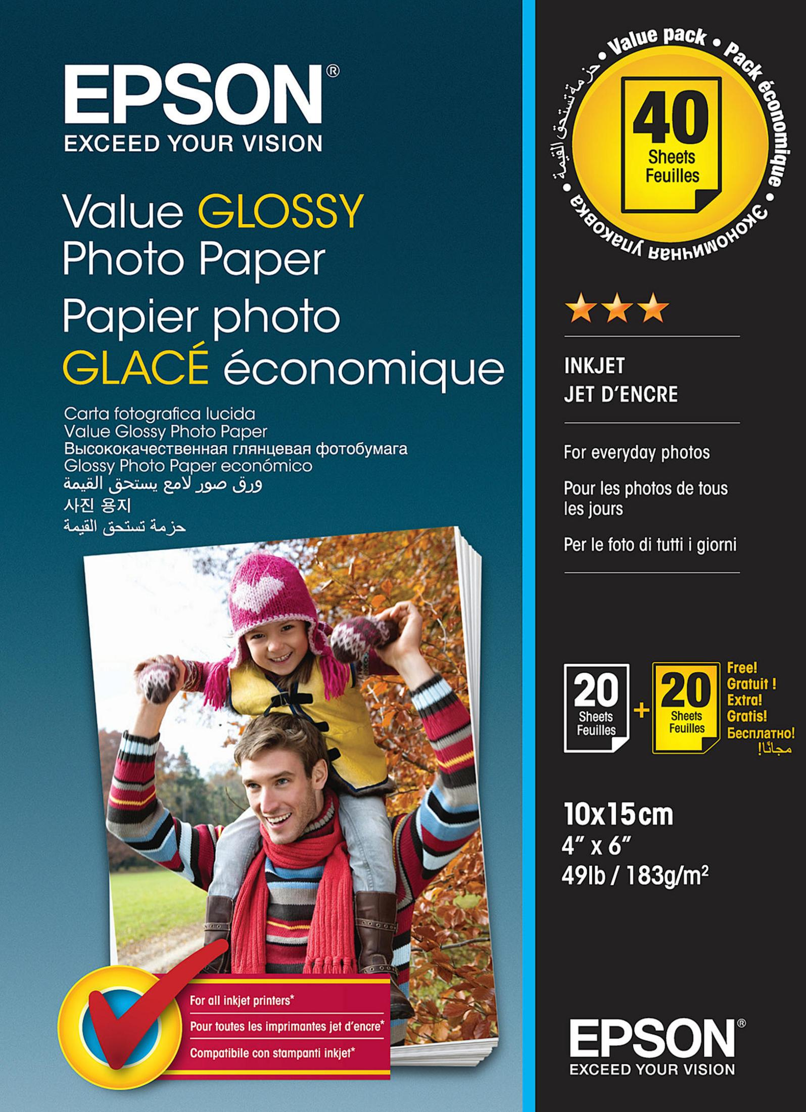 Mann, der ein Kind auf den Schultern hält, lächelnd, mit Fotopapierbox.  Text sagt 'Value Glossy Photo Paper'.