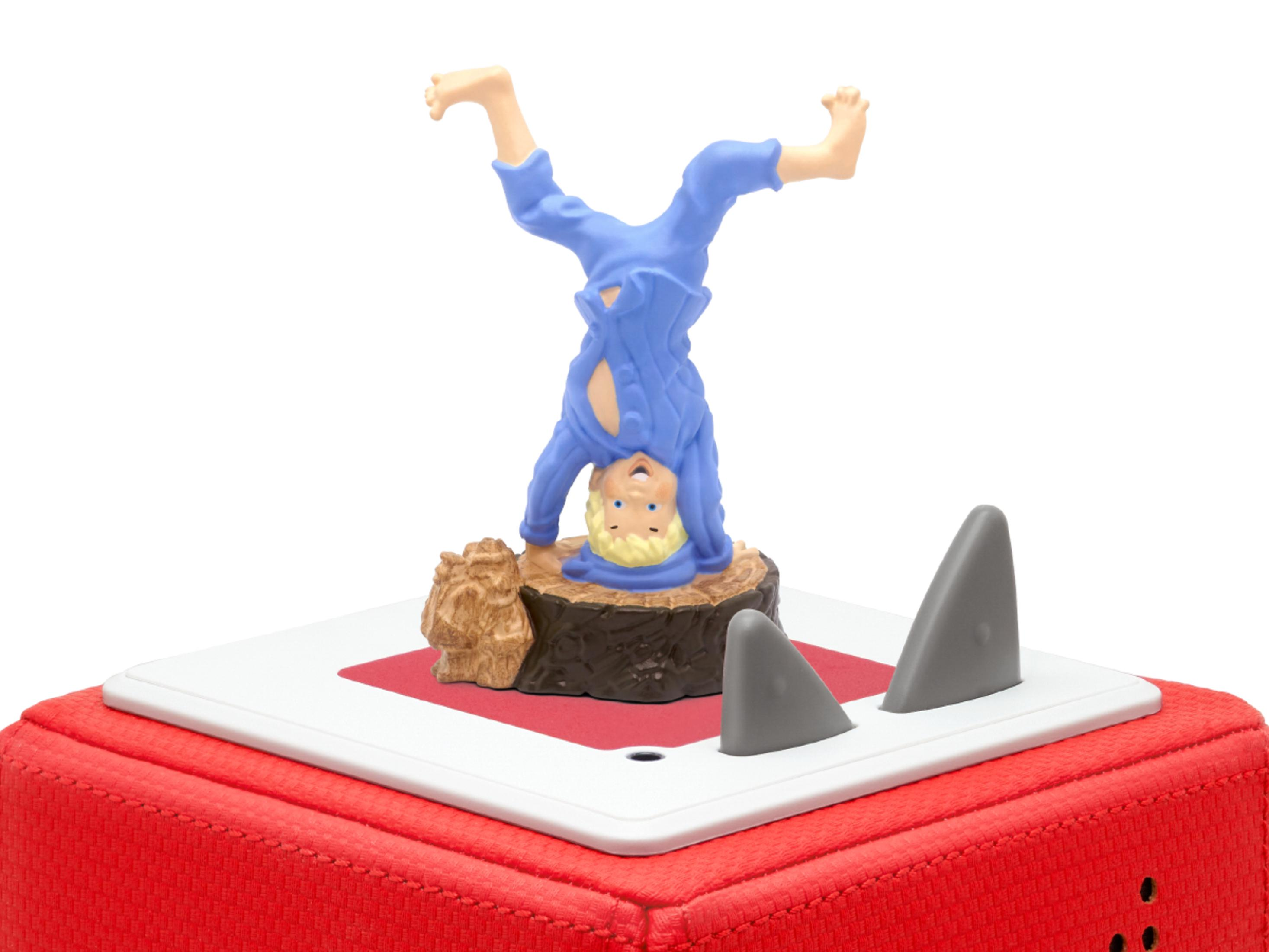 Spielfigur eines Jungen, der einen Handstand macht, mit Haifischflossen und roter Basis.