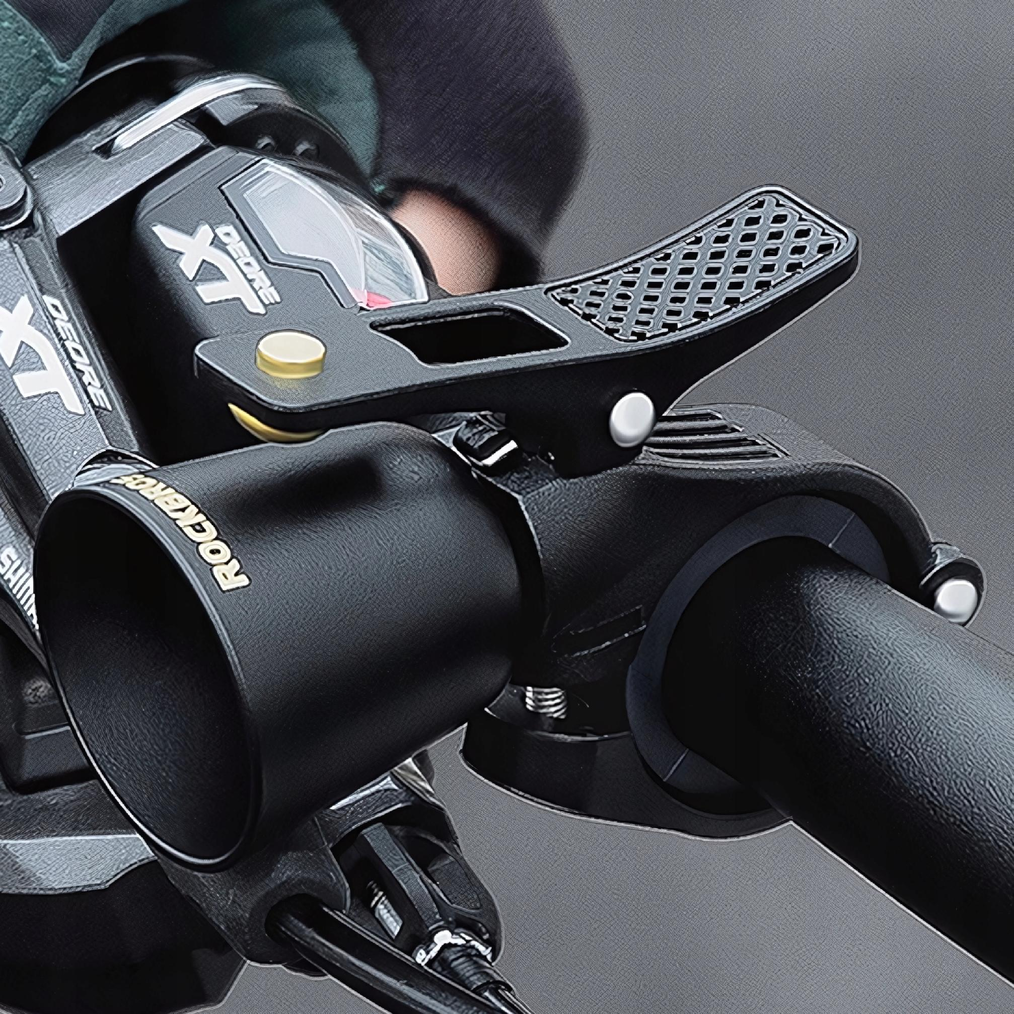 Zbliżenie czarnego dzwonka rowerowego z teksturowaną dźwignią, zamontowanego na kierownicy.