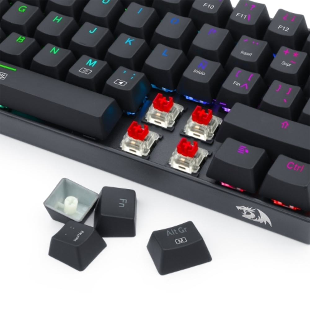 Teclado con teclas negras, interruptores rojos visibles y teclas retiradas. Se muestran varias teclas.