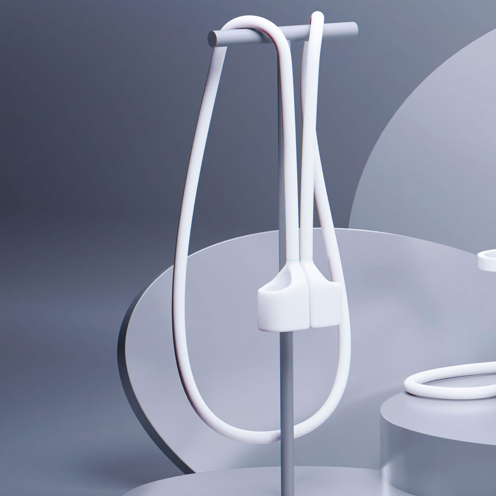 Białe, zakrzywione akcesorium do telefonu na szarej podstawce. Okrągłe elementy w tle.