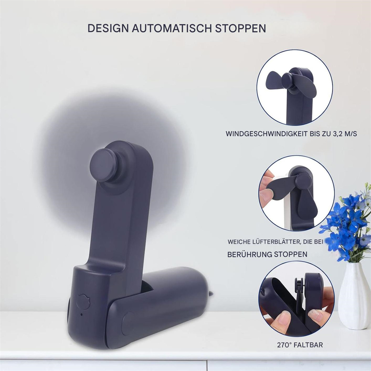 Ein marineblauer tragbarer Ventilator mit offenen Flügeln. Der Ventilator bietet eine Windgeschwindigkeit von bis zu 3,2 m/s und 270° Faltbarkeit.