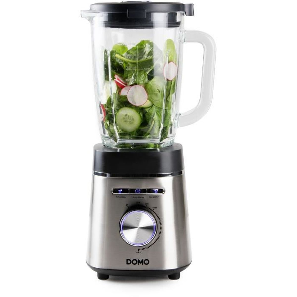 Un frullatore argento e nero con caraffa in vetro piena di verdure, pronto per frullare.