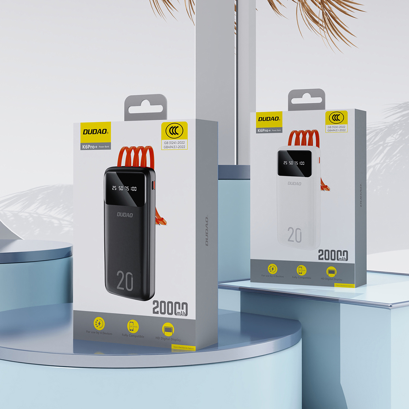 Dwa pudełka z power bankami. Jedno czarne, drugie białe. Oba mówią 20000 mAh.