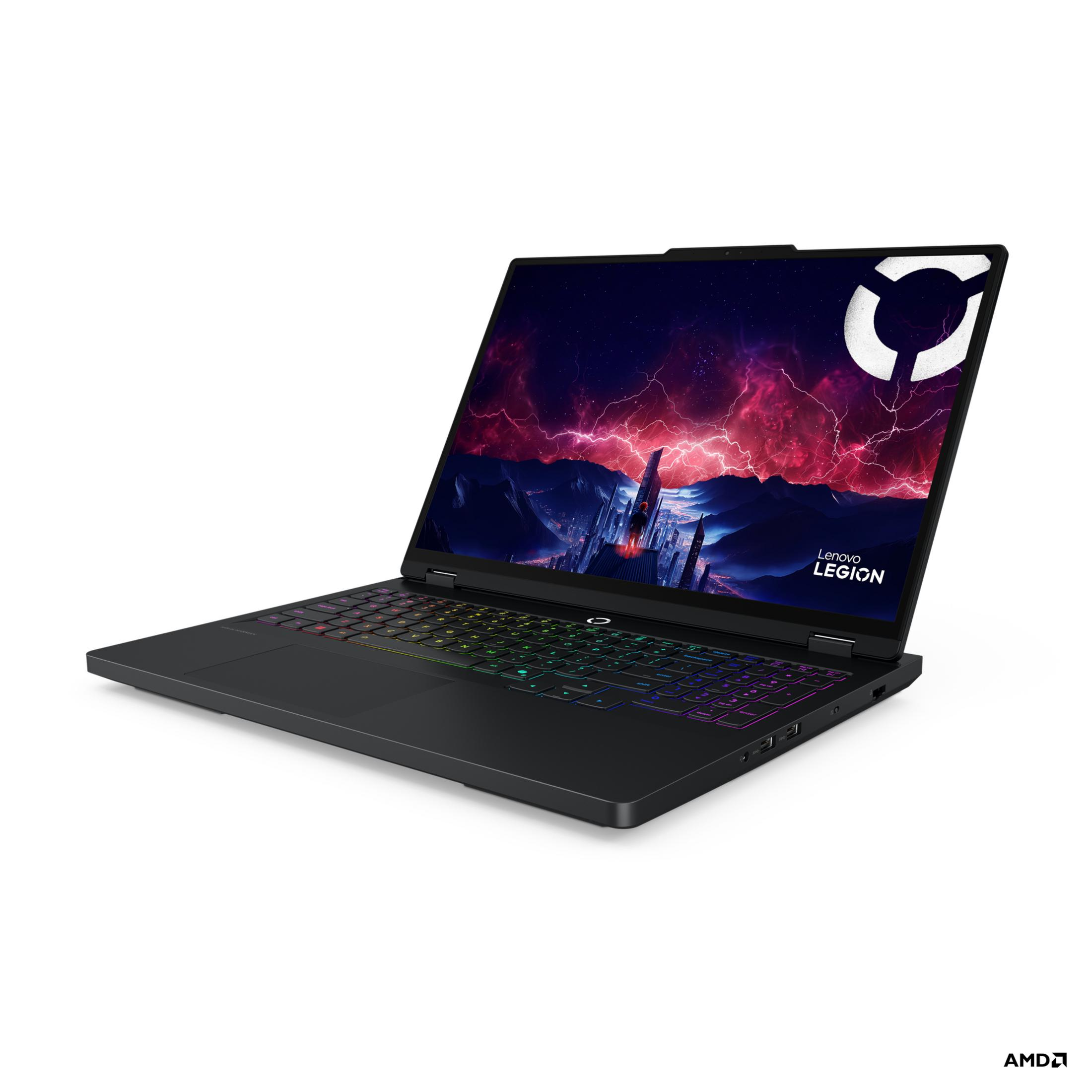 Czarny laptop Lenovo Legion, pokazujący miejski krajobraz na ekranie, z kolorową klawiaturą. Białe tło.