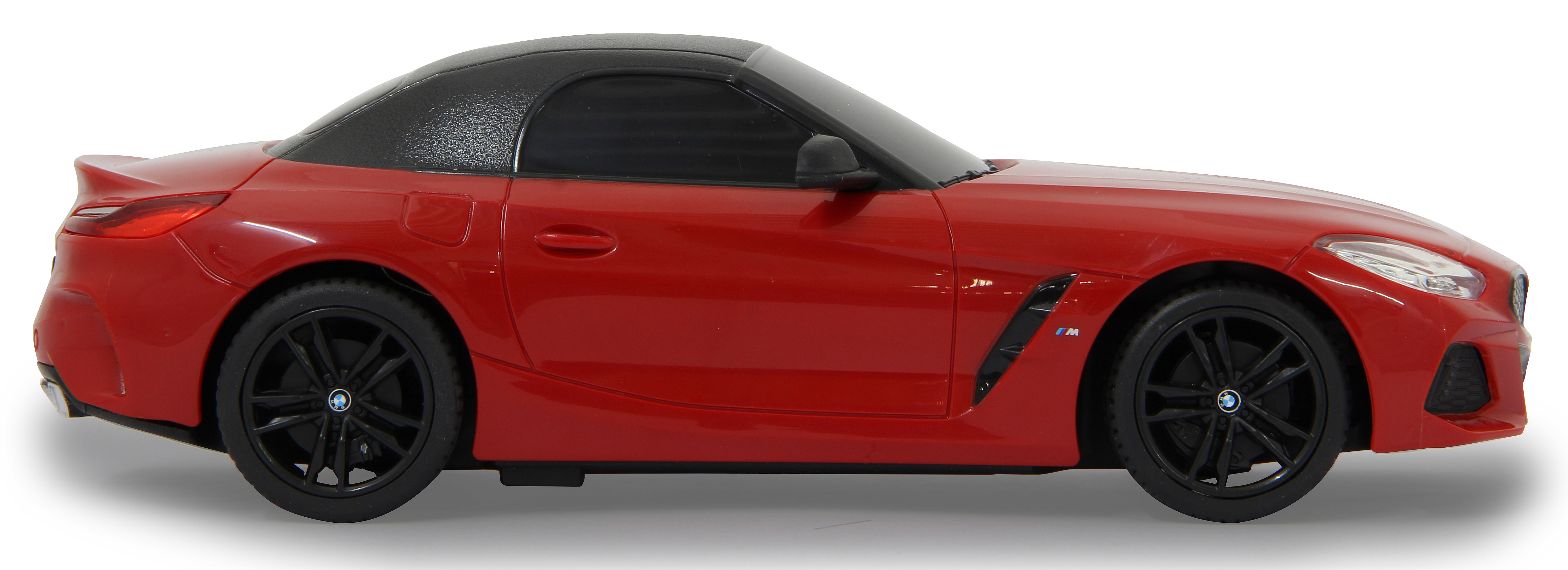 Seitenansicht eines roten BMW Z4 Modellautos mit schwarzem Dach und Rädern, auf weißem Hintergrund.