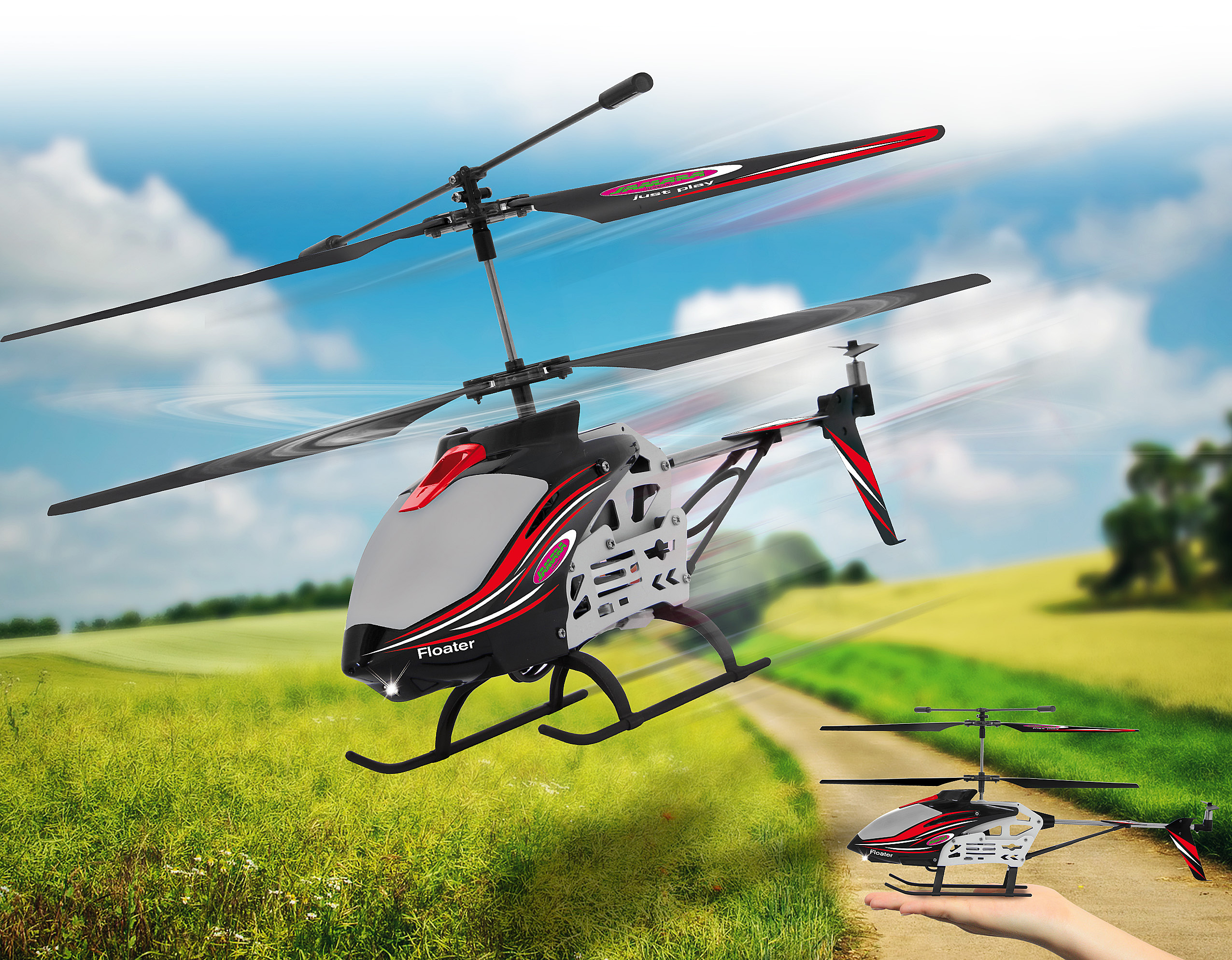 Spielzeughelikopter im Flug über einem Feld, mit einem zweiten Spielzeug in einer Hand.