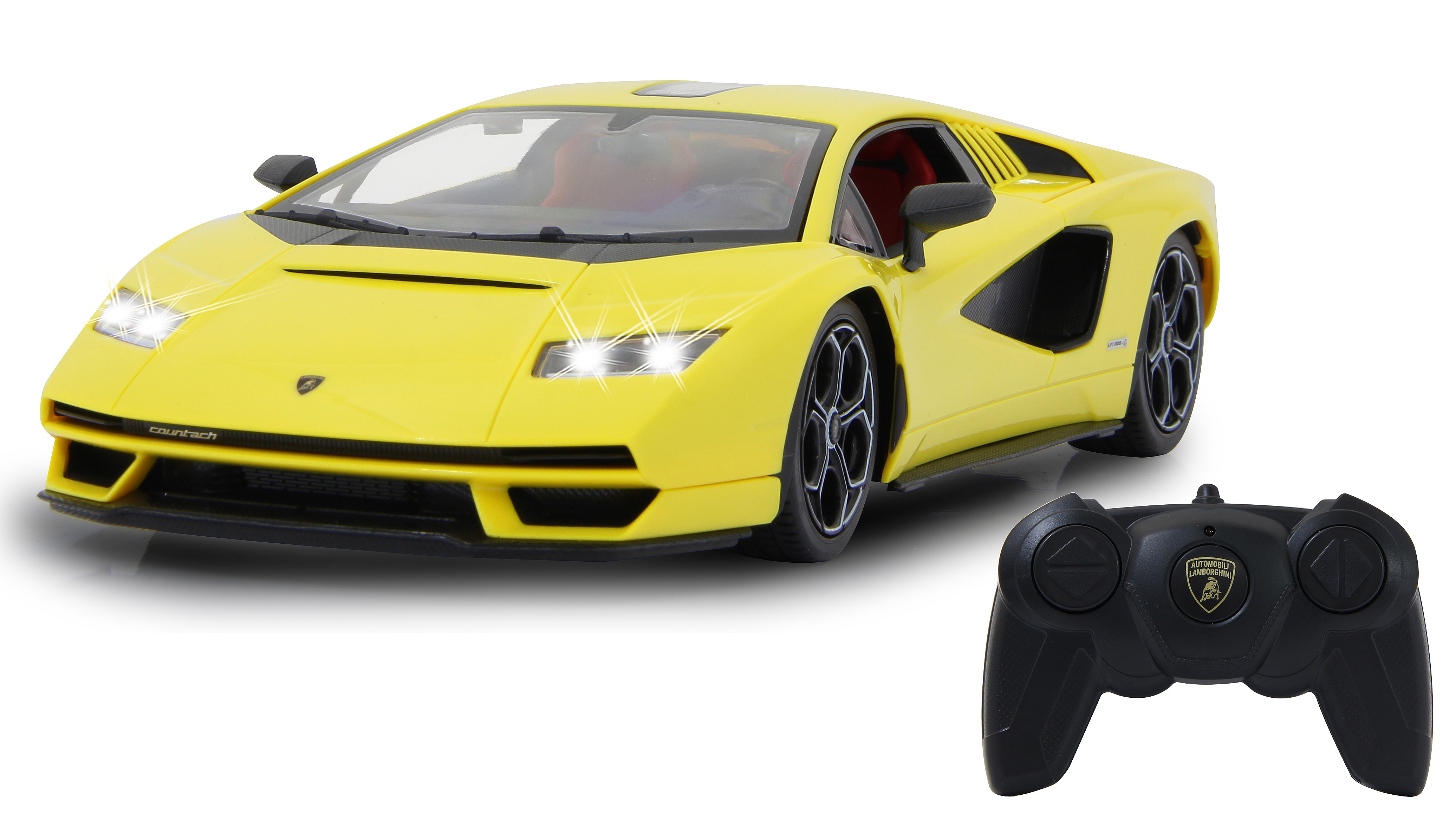 Gelbes Lamborghini Countach Spielzeugauto mit schwarzer Fernbedienung, Scheinwerfer an.