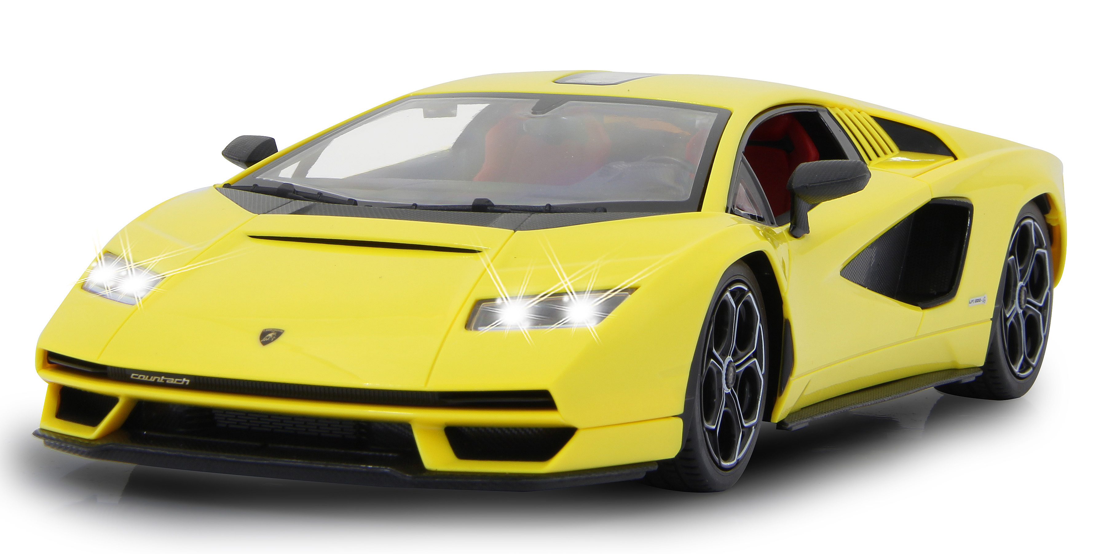 Gelbes Lamborghini Countach Spielzeugauto mit schwarzen Rädern und Scheinwerfern auf weißem Hintergrund.