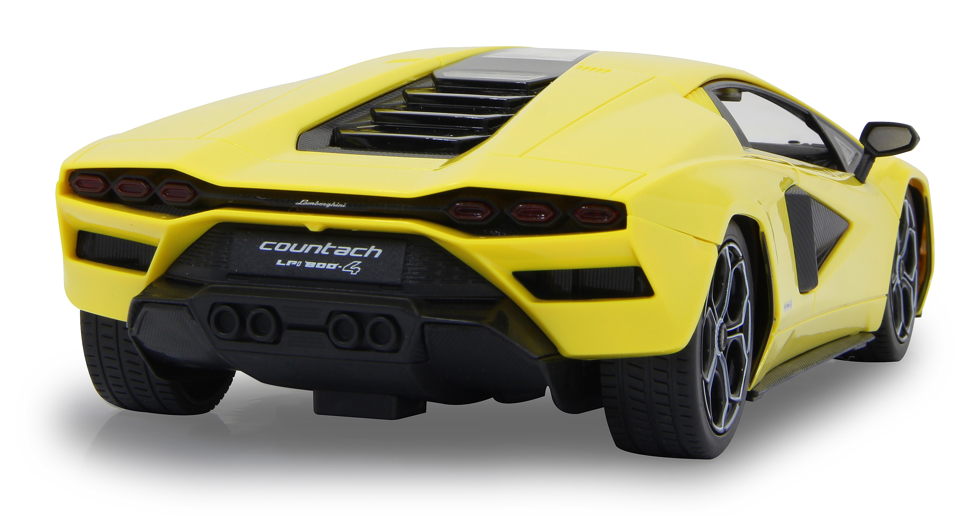 Rückansicht eines gelben Lamborghini Countach Spielzeugautos auf weißem Hintergrund, mit schwarzen Akzenten und Rädern.