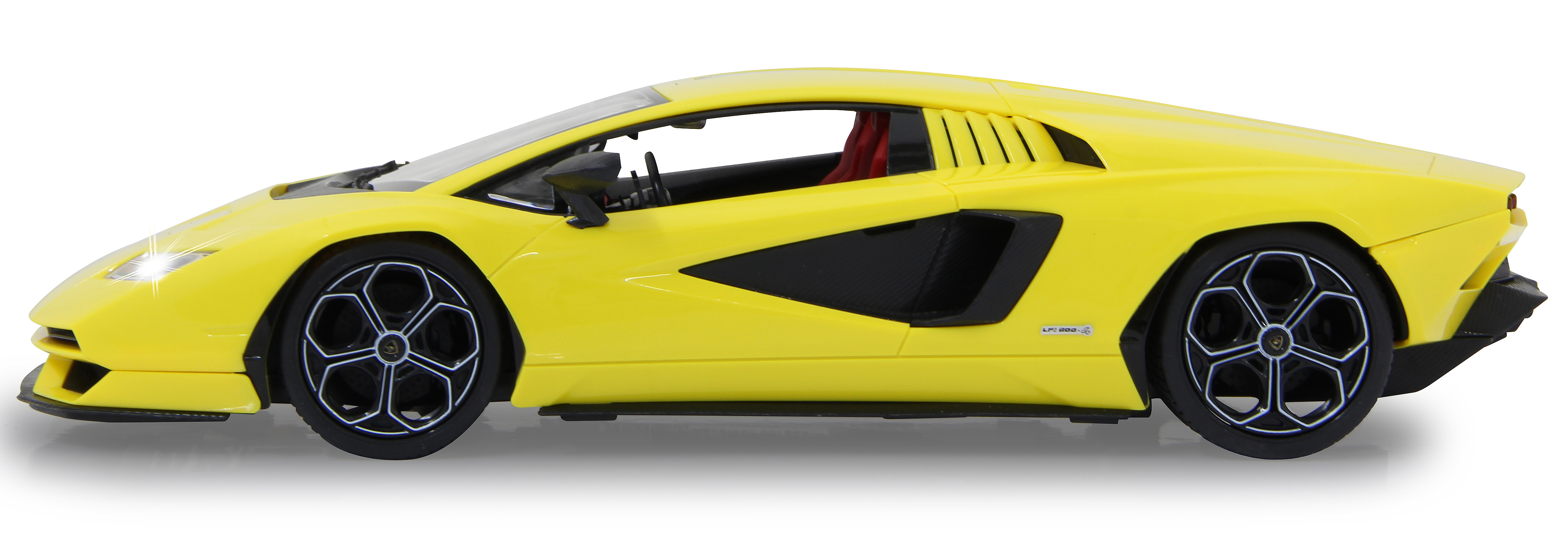 Seitenansicht eines gelben Lamborghini Countach Spielzeugautos mit schwarzen Akzenten und Rädern auf weißem Hintergrund.