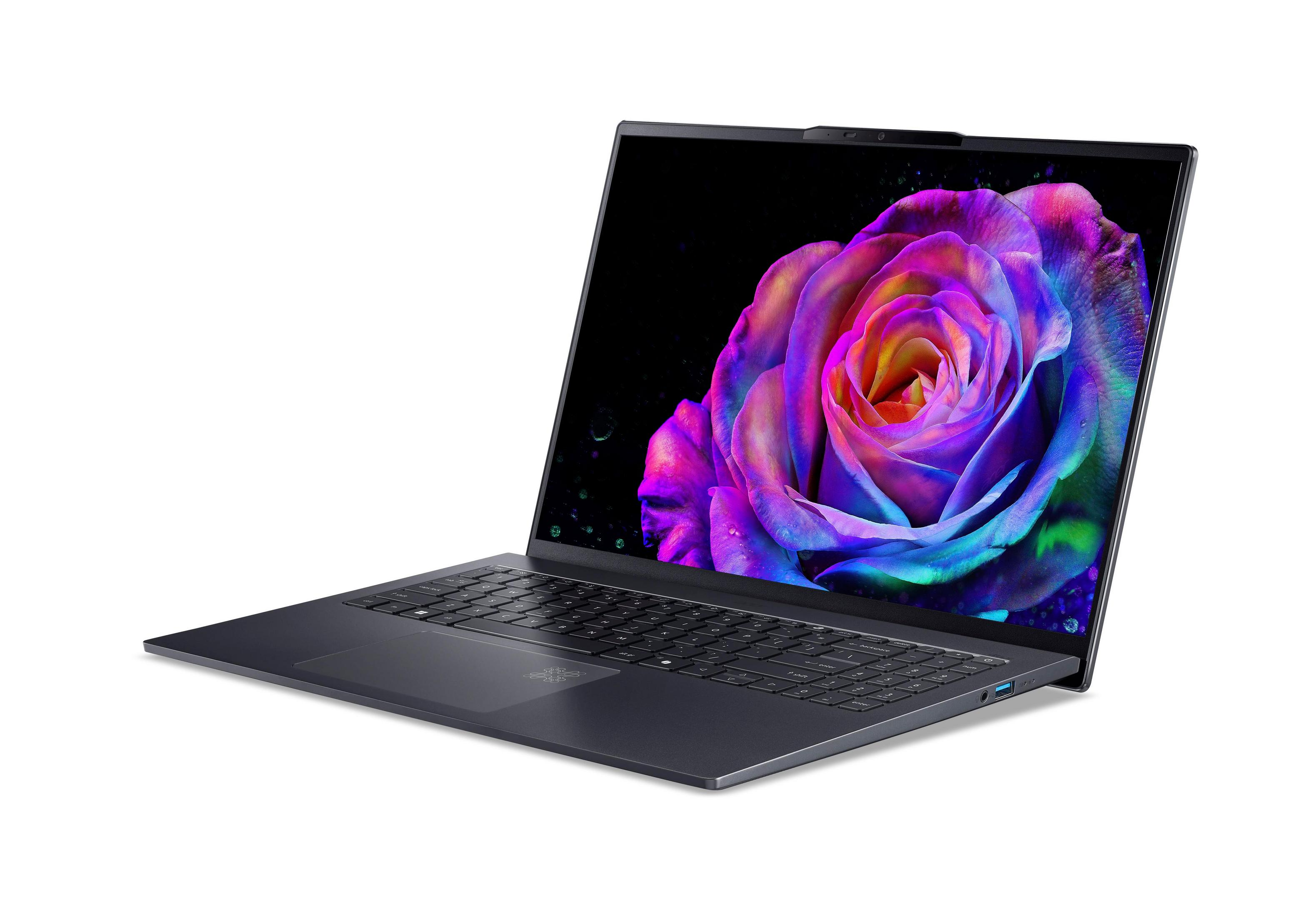 Laptop z ekranem OLED pokazujący kolorowy obraz róży, czarne tło.