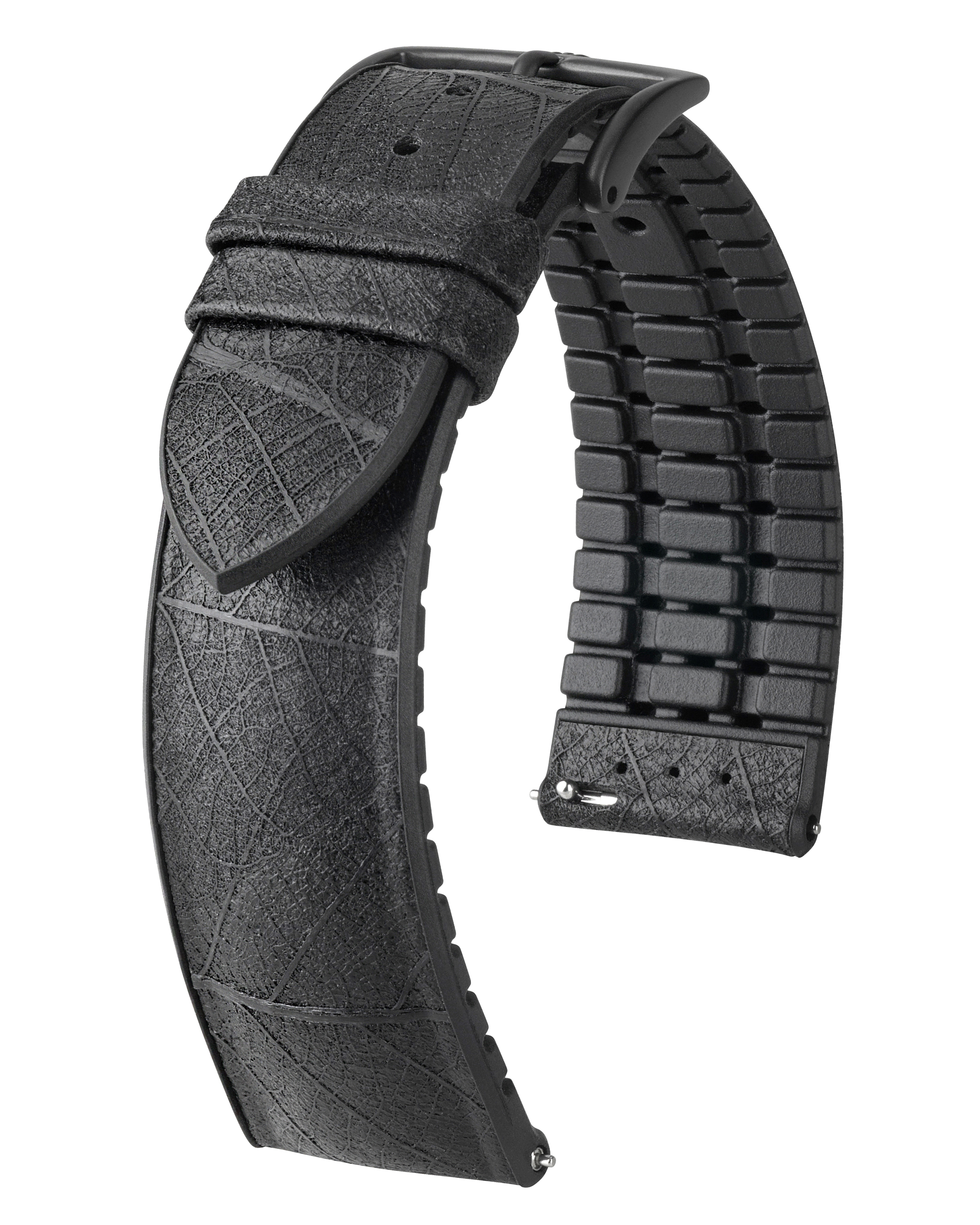 Schwarzes Uhrenarmband mit strukturierter Oberfläche, Blattmuster. Teil des Armbands ist schwarzer Gummi mit Ziegelmuster.