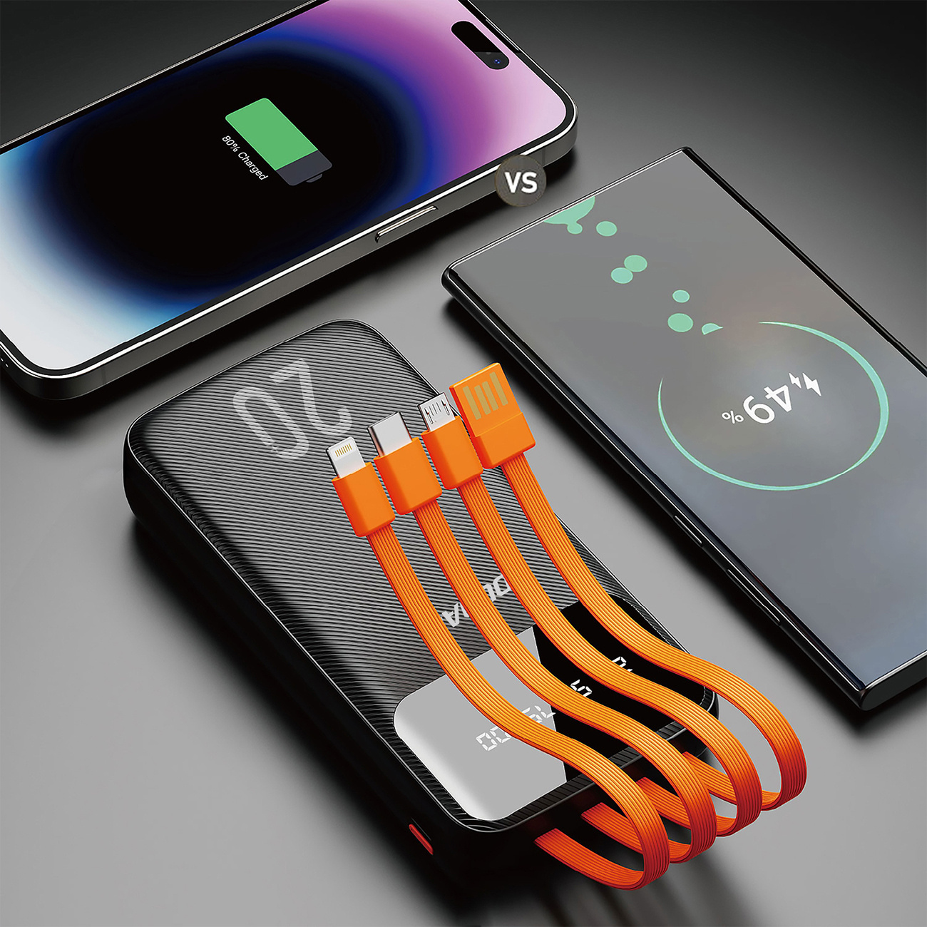 Czarny power bank z pomarańczowymi kablami ładujący dwa telefony. Jeden telefon się ładuje, drugi naładowany.