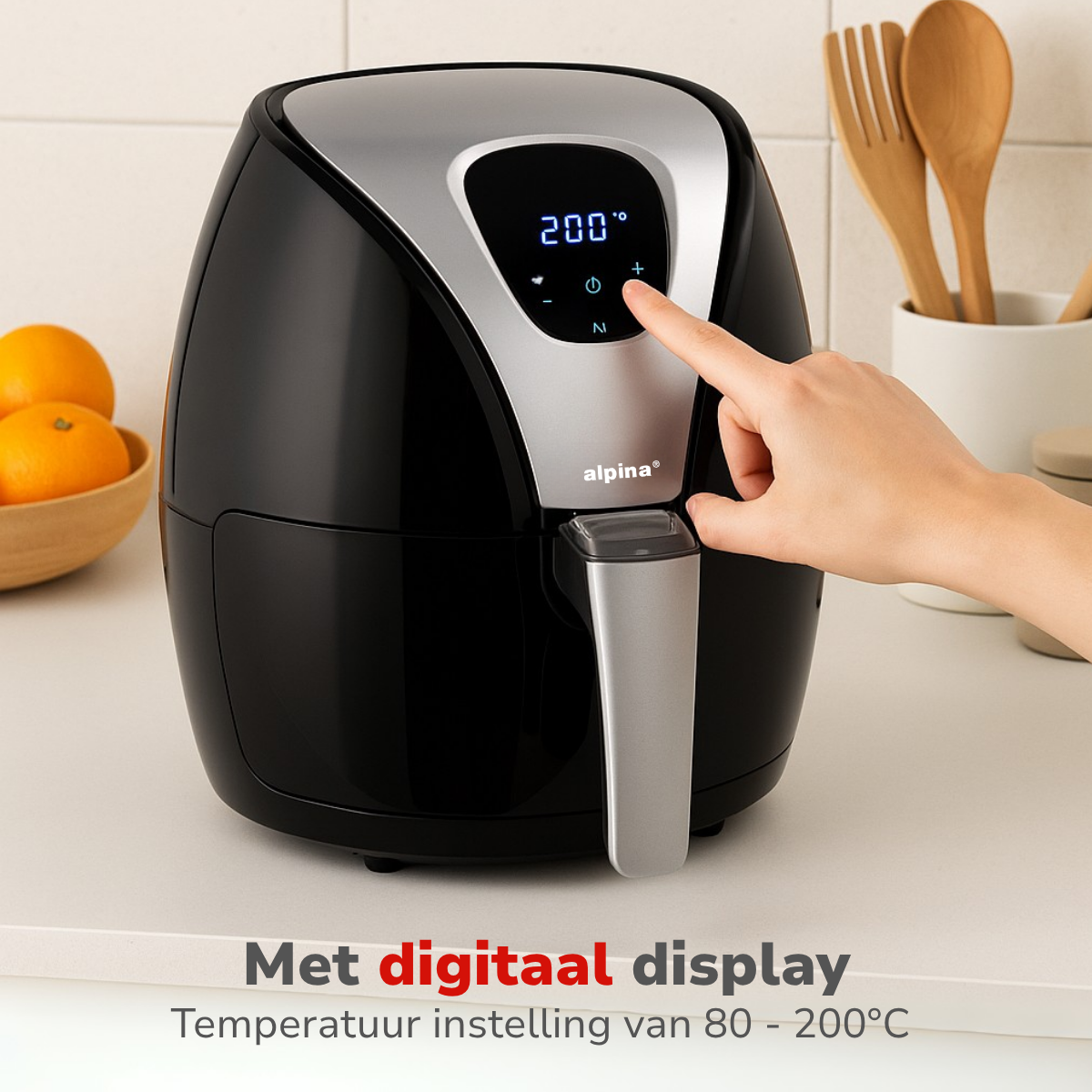 Black and silver air fryer, a hand is pressing a button.