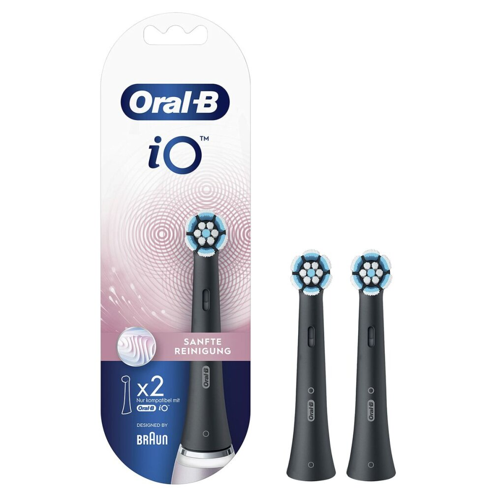 Due testine per spazzolino nere con setole blu e bianche, accanto alla confezione. Sfondo bianco.
