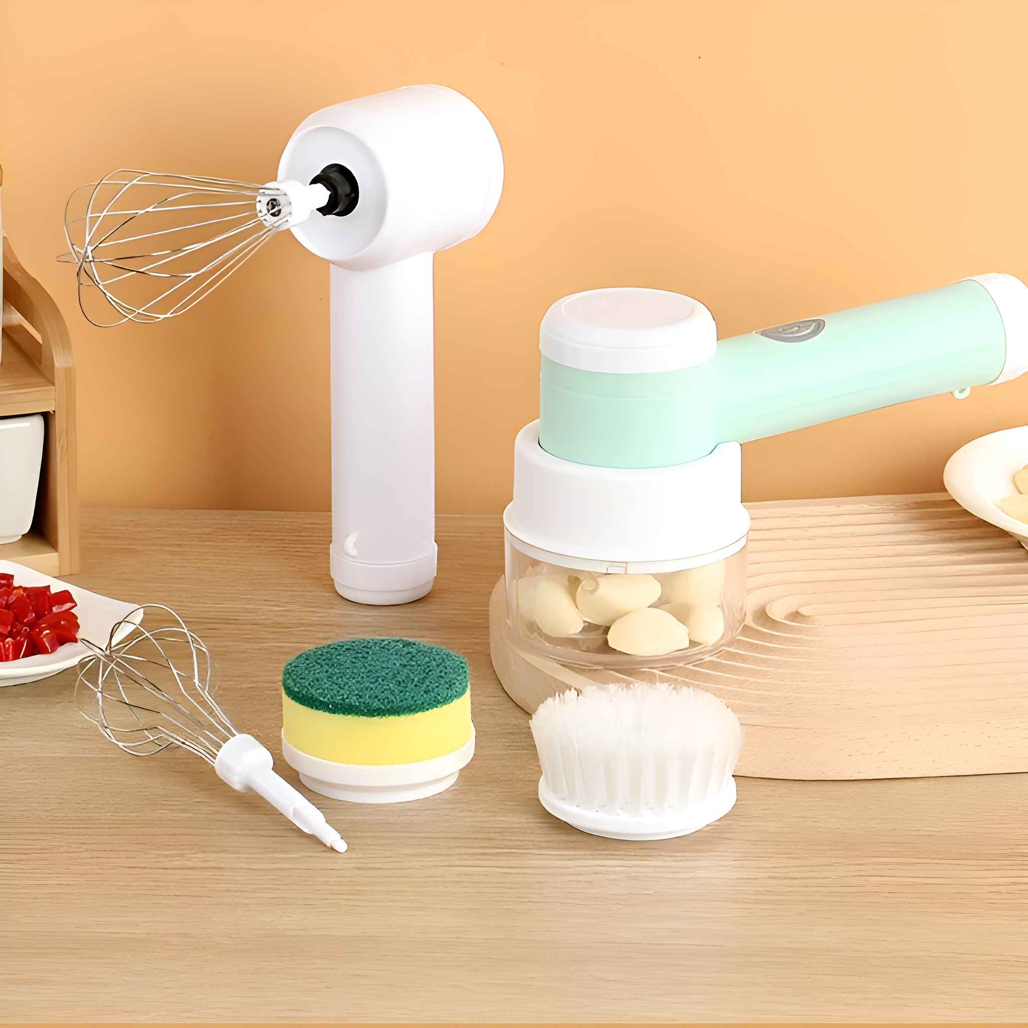 Küchenutensilien: ein Handmixer, ein kleiner Knoblauchhacker und Reinigungsartikel auf Holzoberfläche.