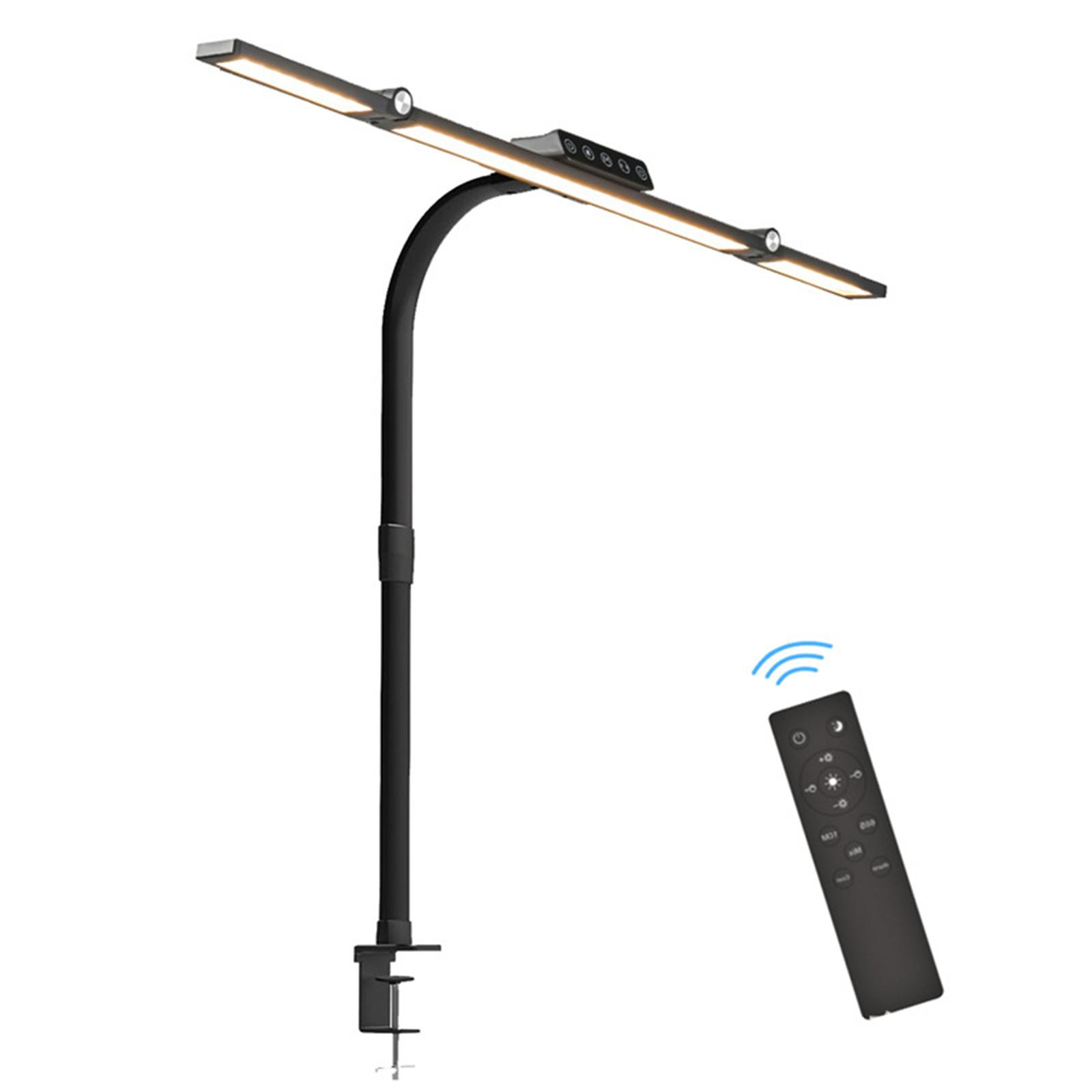 Schwarze Schreibtischlampe mit zwei LED-Leuchten, Klemmfuß und Fernbedienung, auf weißem Hintergrund.