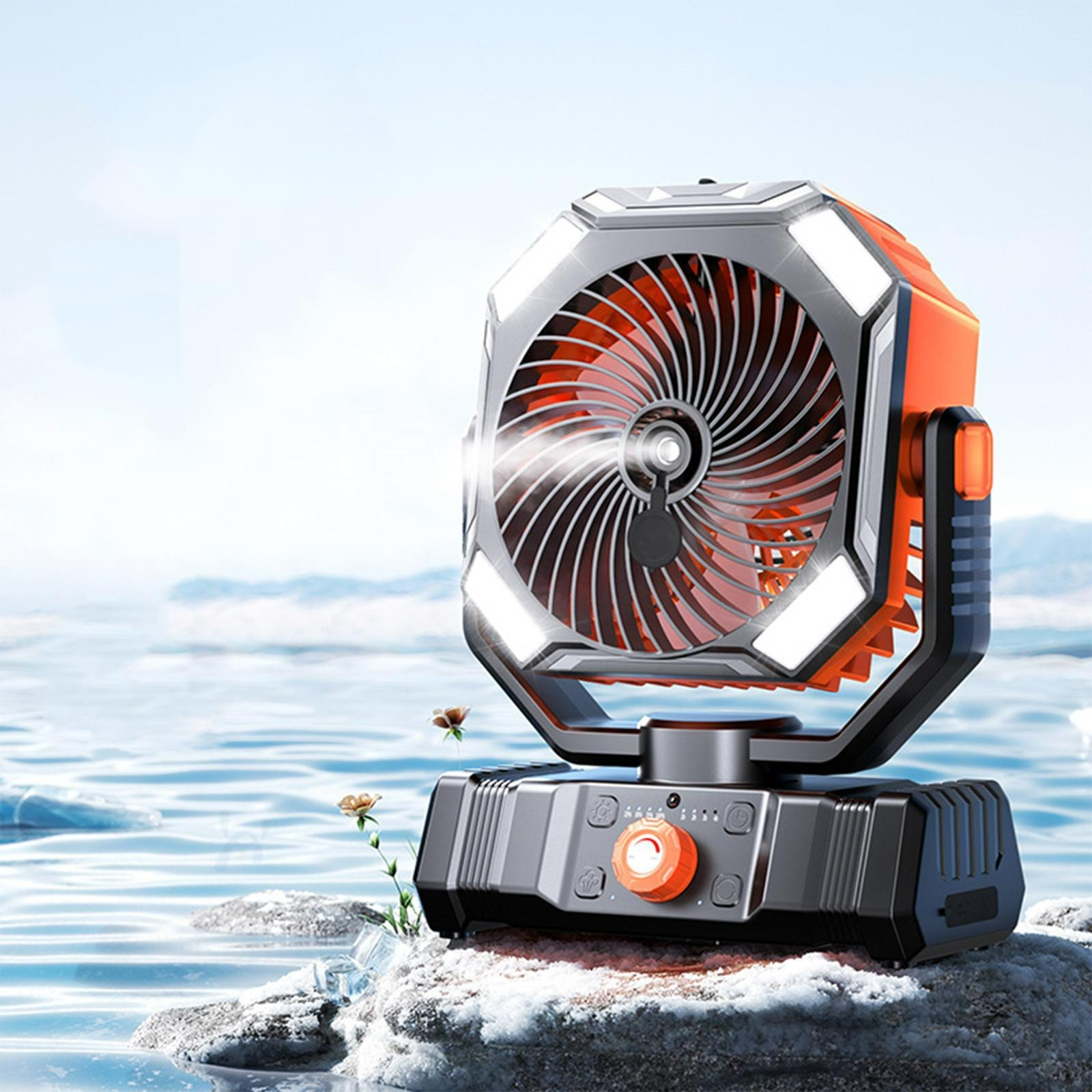 Ein tragbarer Ventilator mit Lichtern auf einem Felsen im Wasser. Der Ventilator ist orange und schwarz.