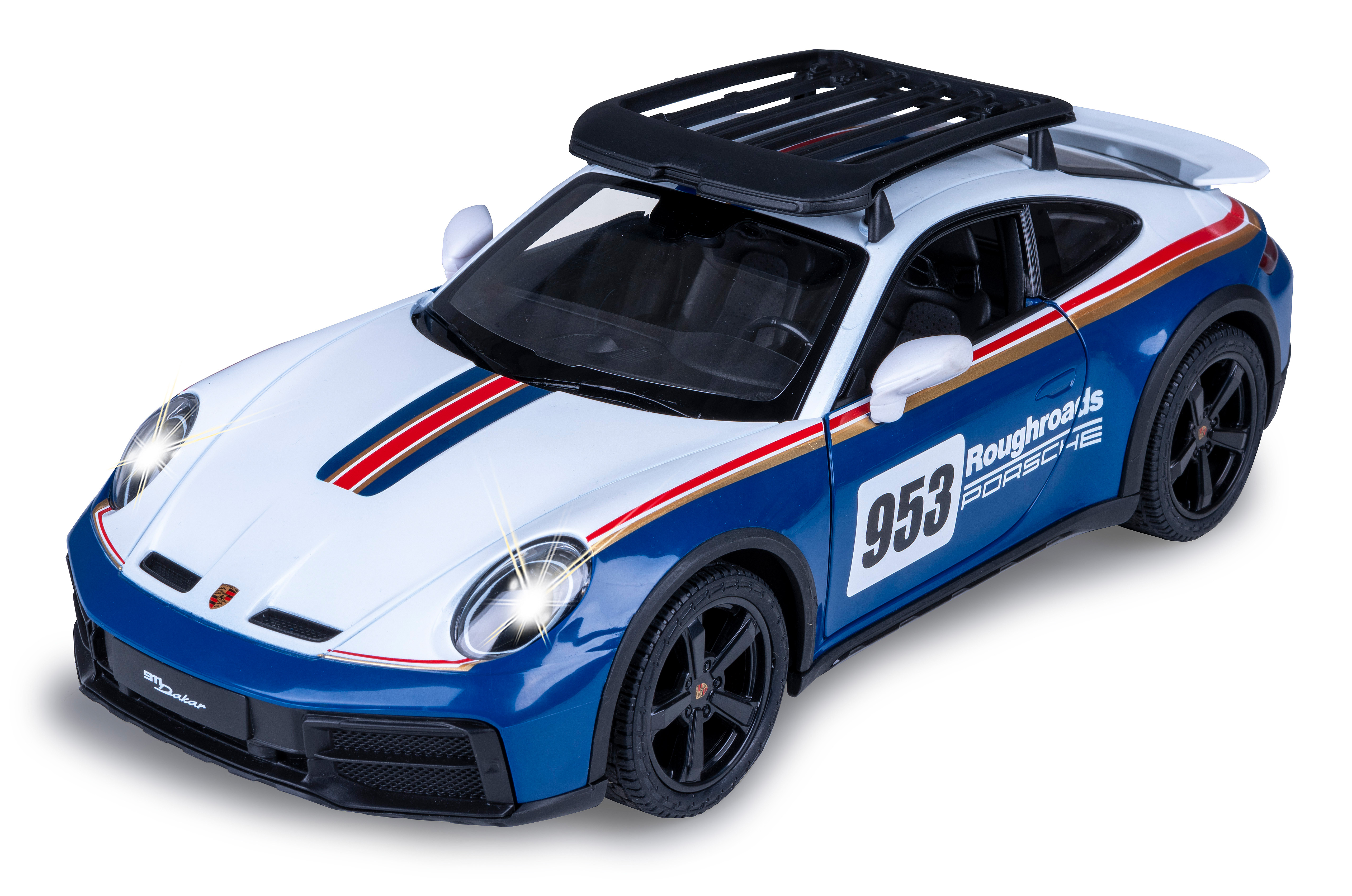 Ein Spielzeug-Porsche 911 Dakar, blau und weiß, mit Dachgepäckträger. Die Scheinwerfer sind an und die 953 sichtbar.