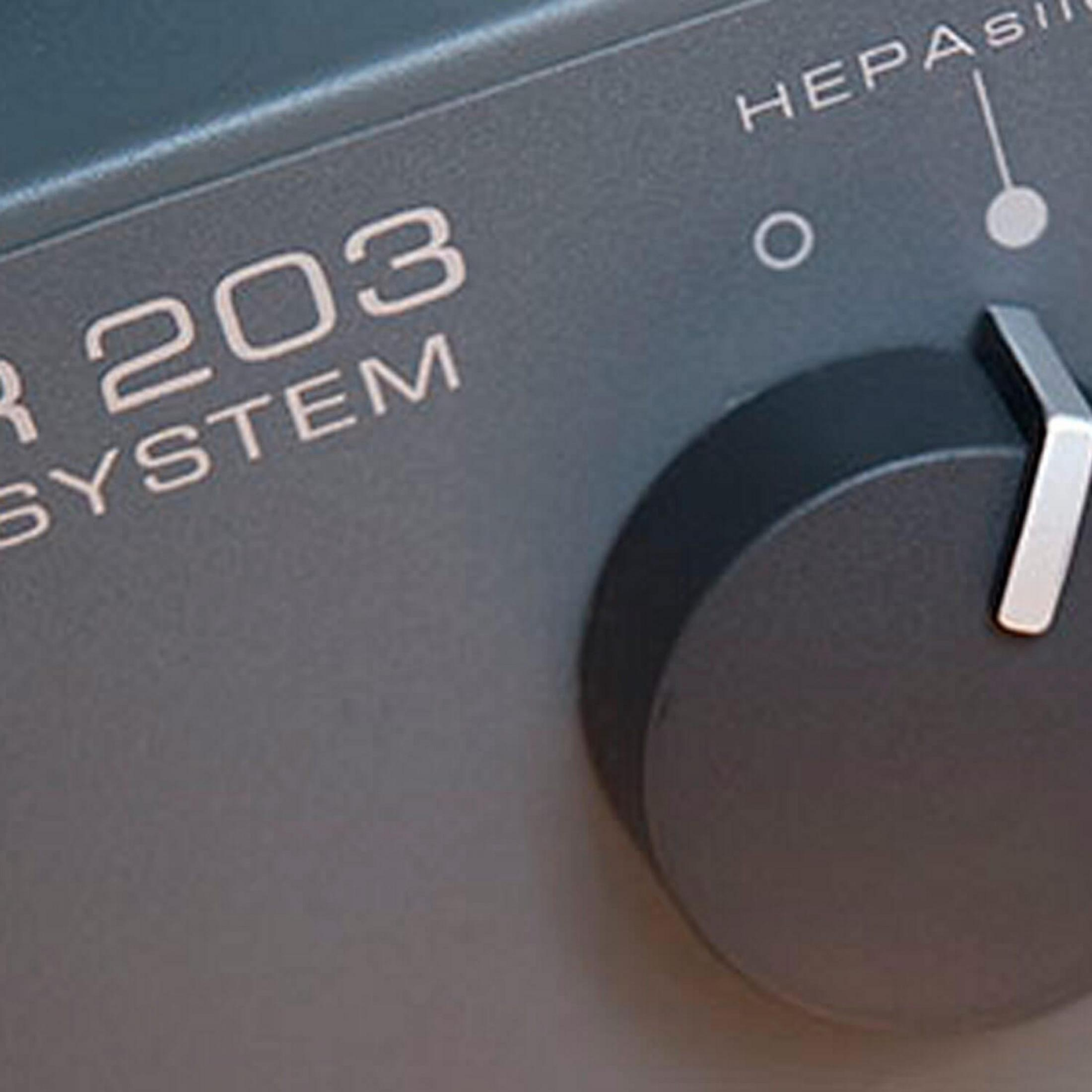 Close-up of a dark gray device. A dial and text are visible. The word 'HEPAs' is also visible.