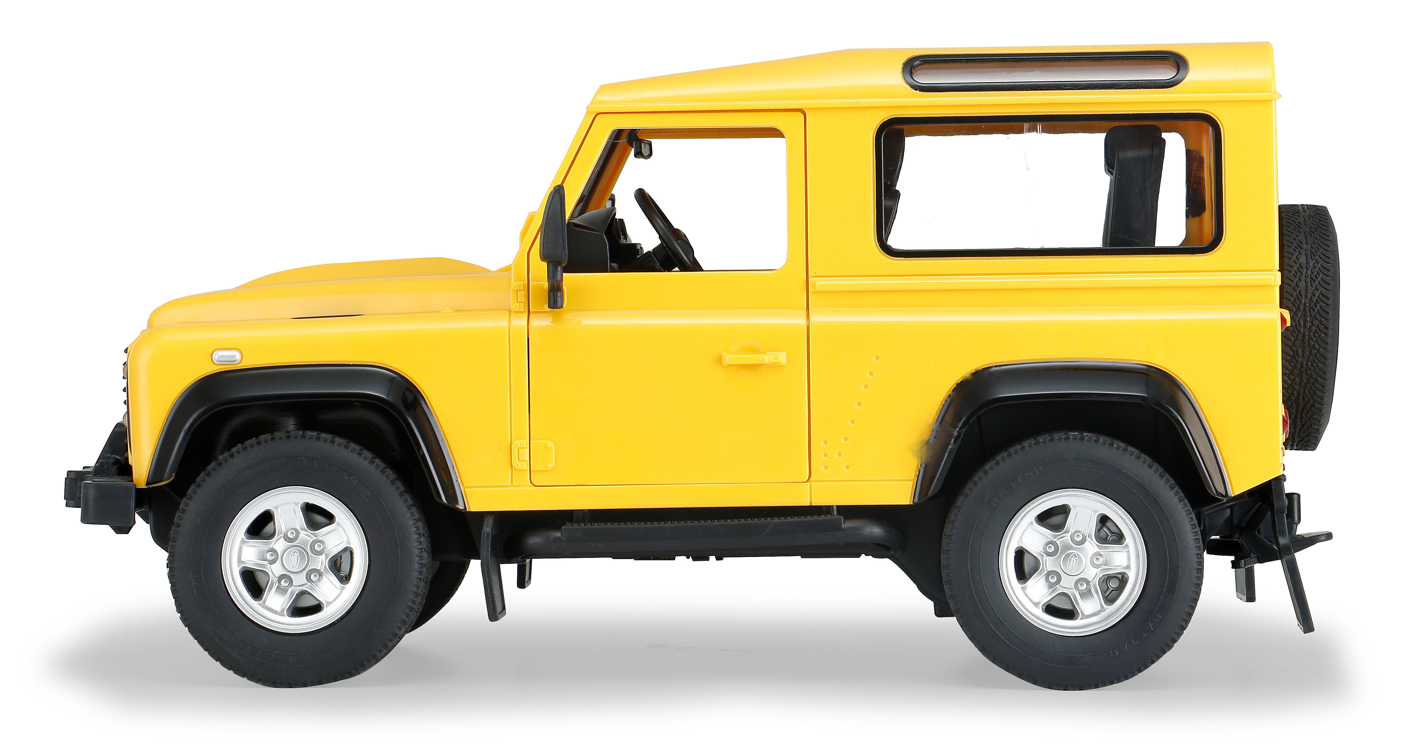 Seitenansicht eines gelben Land Rover Defender Spielzeugautos auf weißem Untergrund.