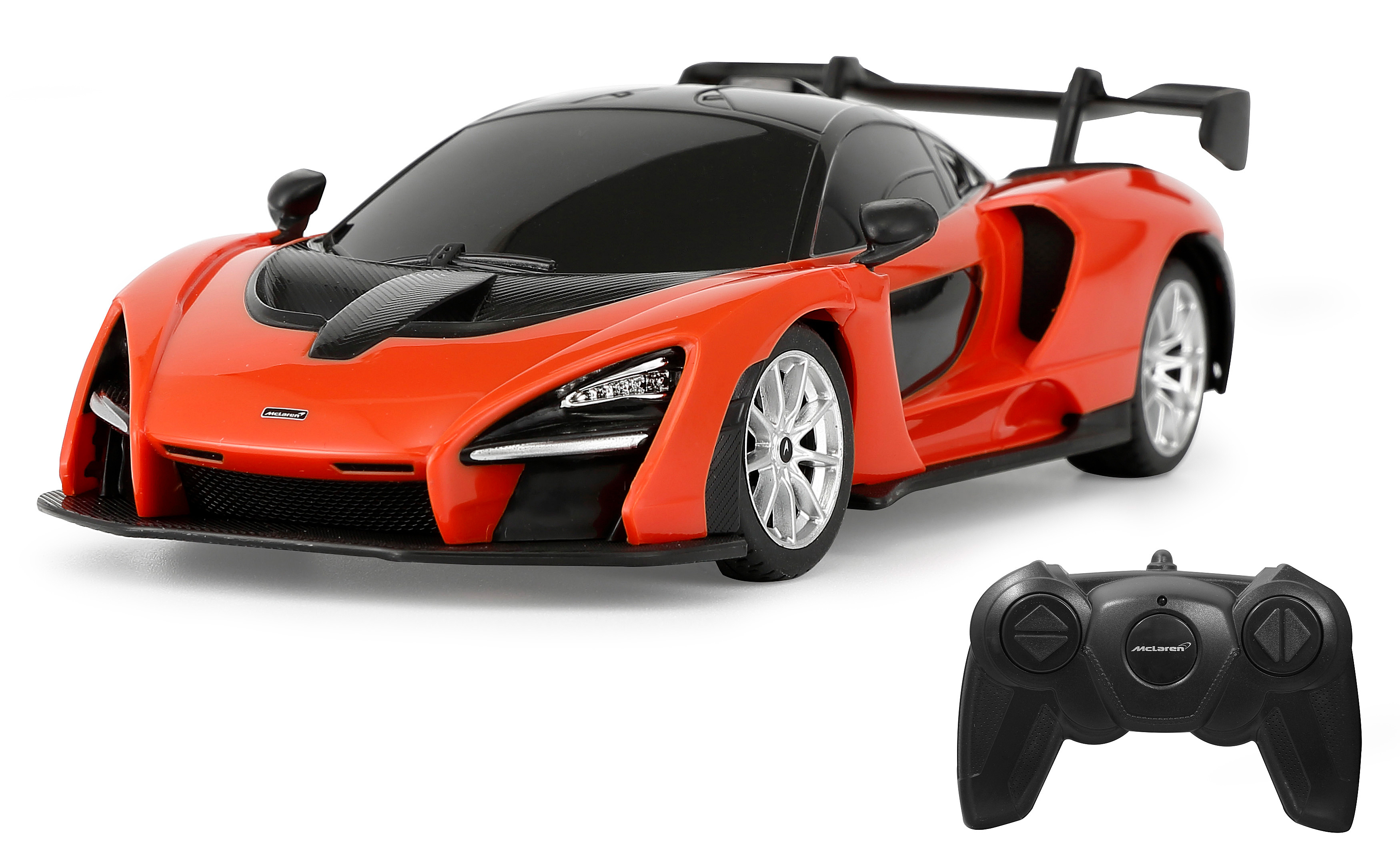 Oranges McLaren-Spielzeugauto mit schwarzem Dach und Spoiler sowie eine schwarze Fernbedienung auf weißem Hintergrund.