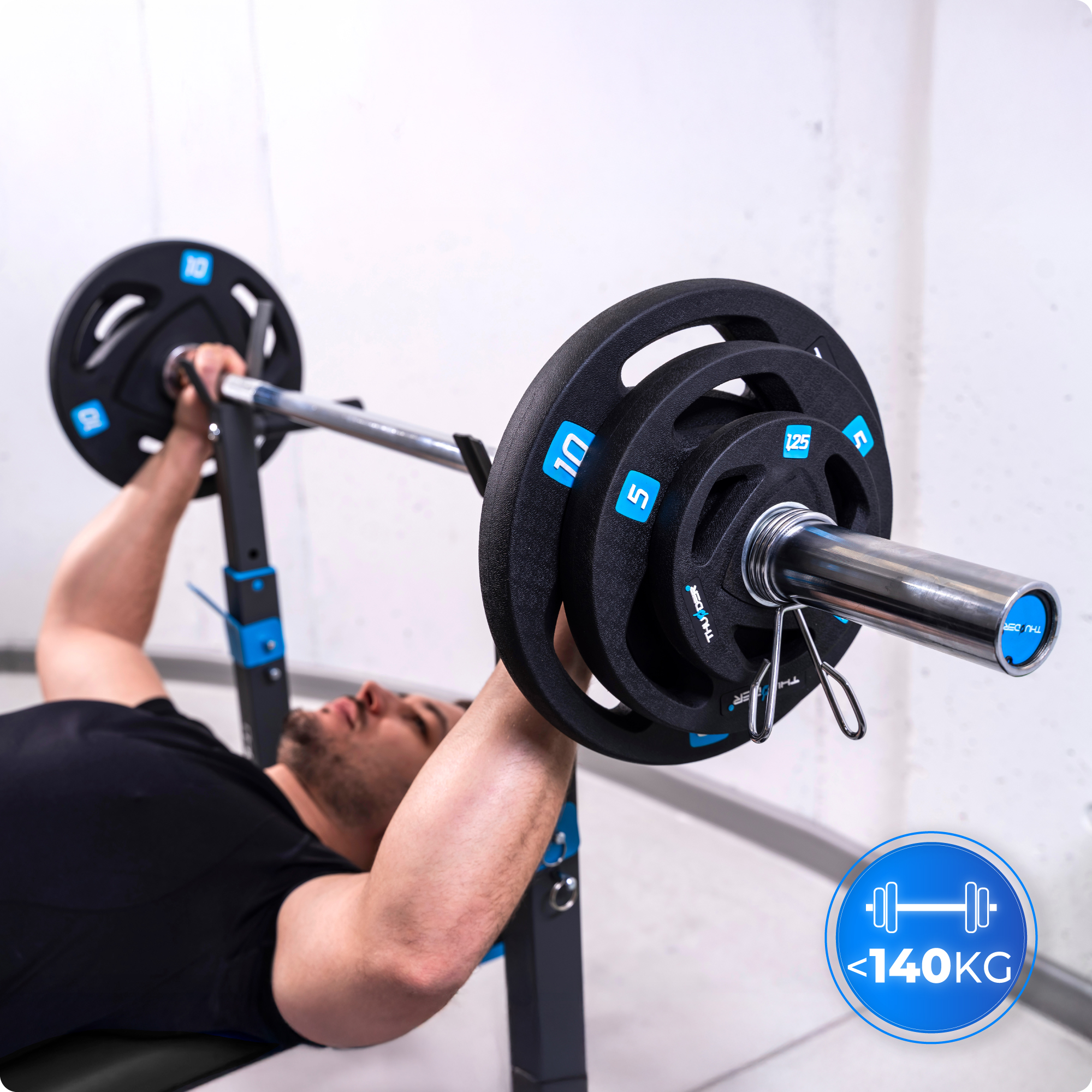 Mężczyzna wyciska ciężary na ławce. Leży na ławce, podnosząc sztangę.