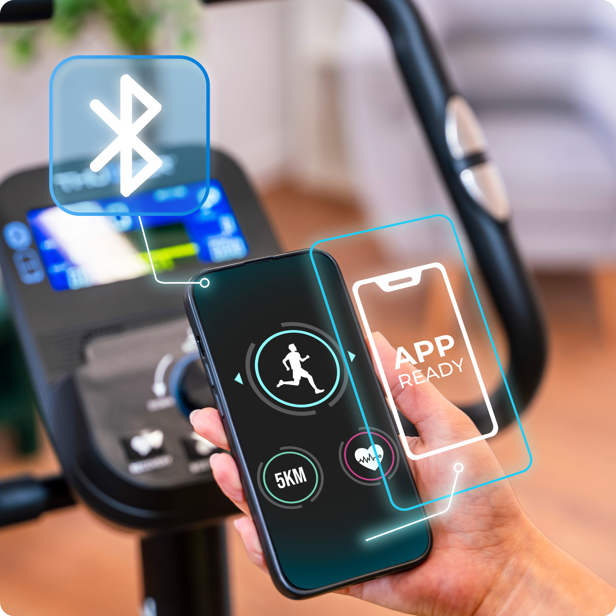 Smartfon połączony z rowerem treningowym. Telefon pokazuje interfejs aplikacji z ikoną biegania.