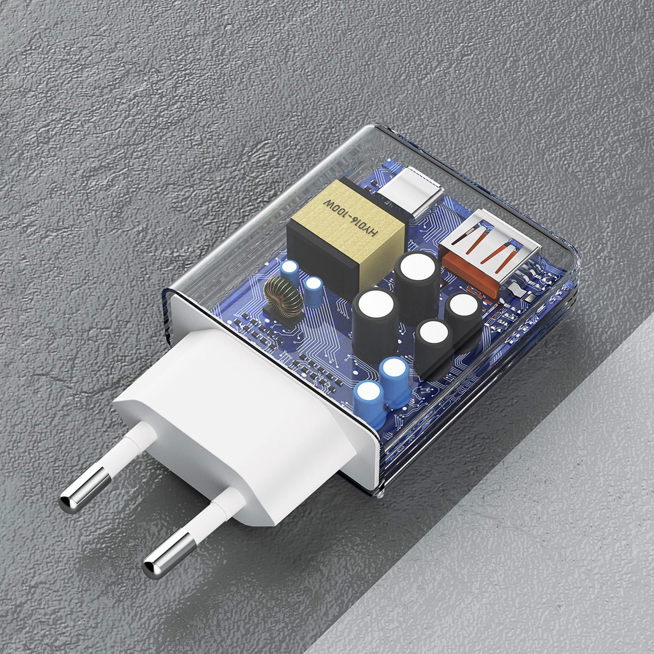 Przezroczysta ładowarka z widocznymi elementami wewnętrznymi. Ma dwa piny i niebieską płytkę obwodu drukowanego.
