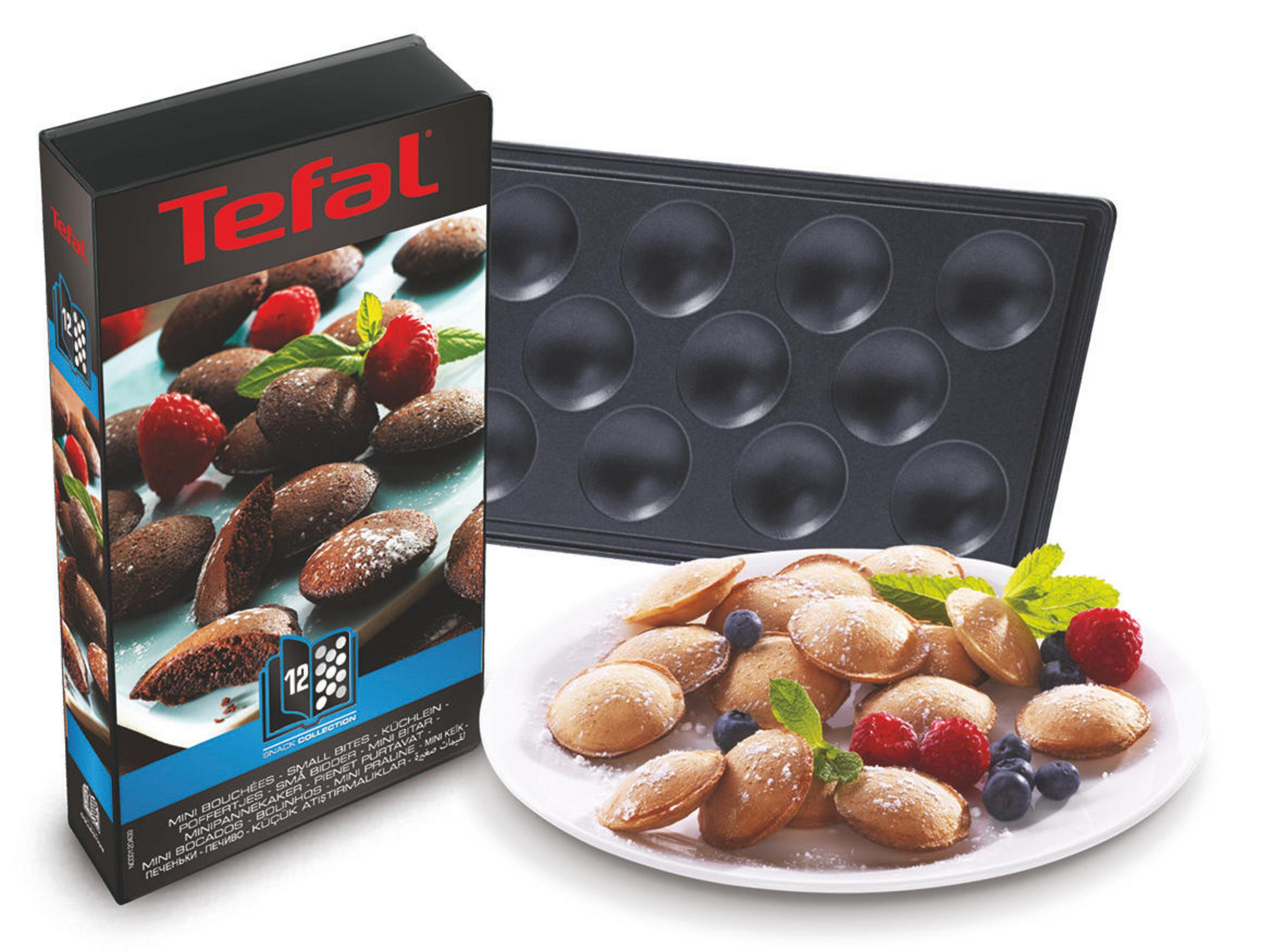 Eine Schachtel und ein Teller mit Essen. Weißer Hintergrund.