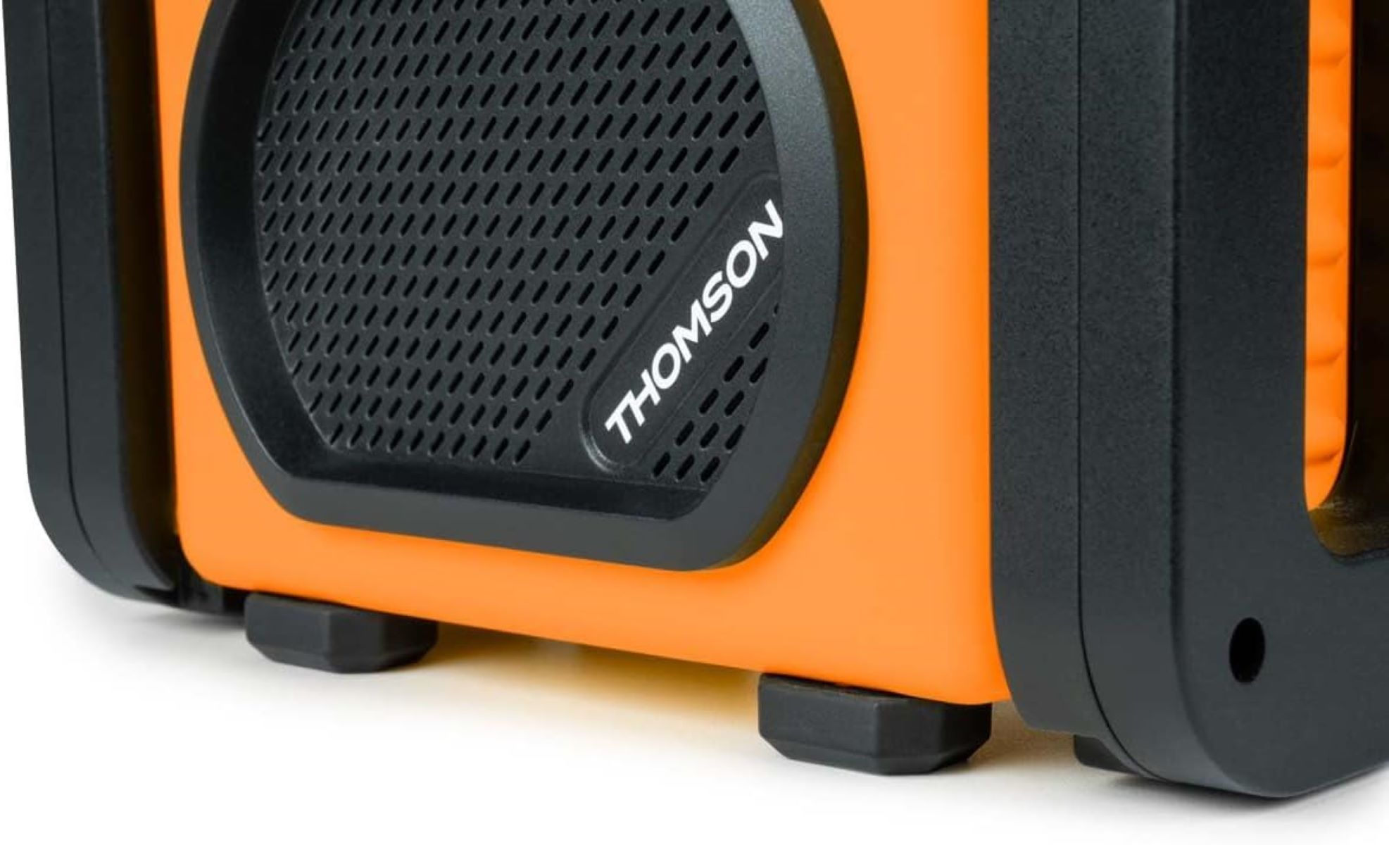 Zbliżenie pomarańczowego głośnika z czarną kratką i czarnymi nóżkami.