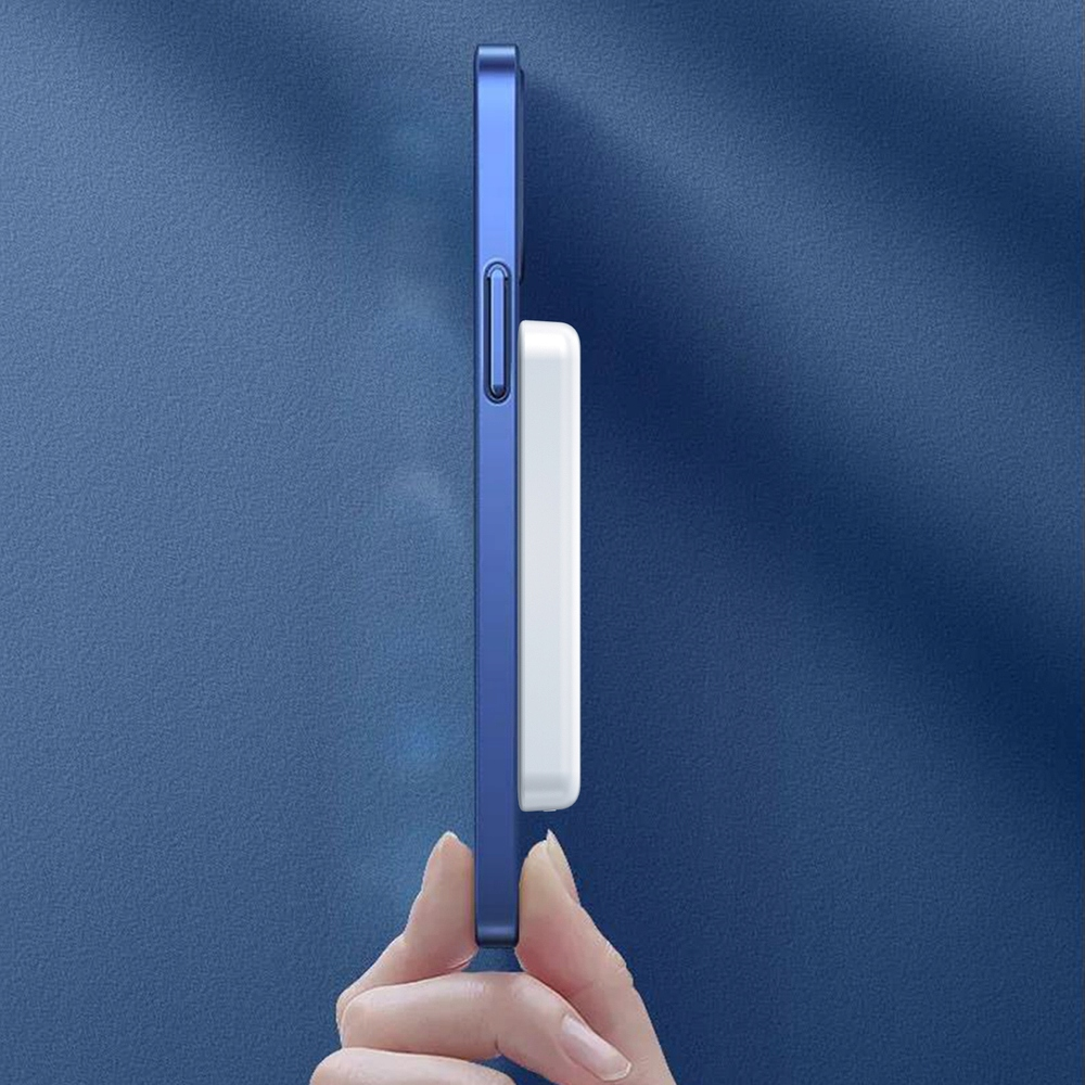 Ręka trzymająca telefon z niebieskim etui. Biała ładowarka jest przymocowana do tyłu telefonu.