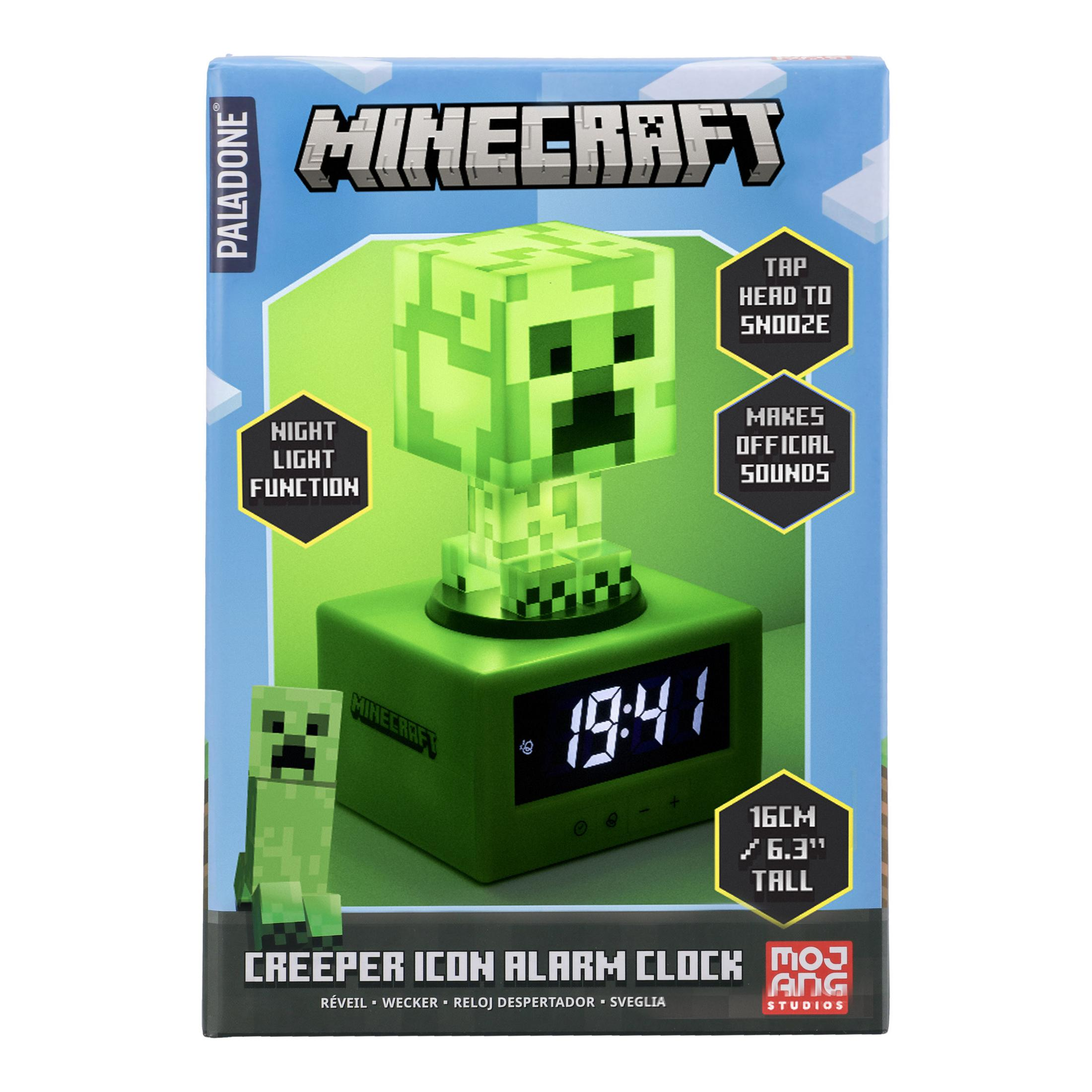 Budzik Minecraft Creeper w pudełku, z zieloną figurką Creepera i cyfrowym wyświetlaczem czasu.