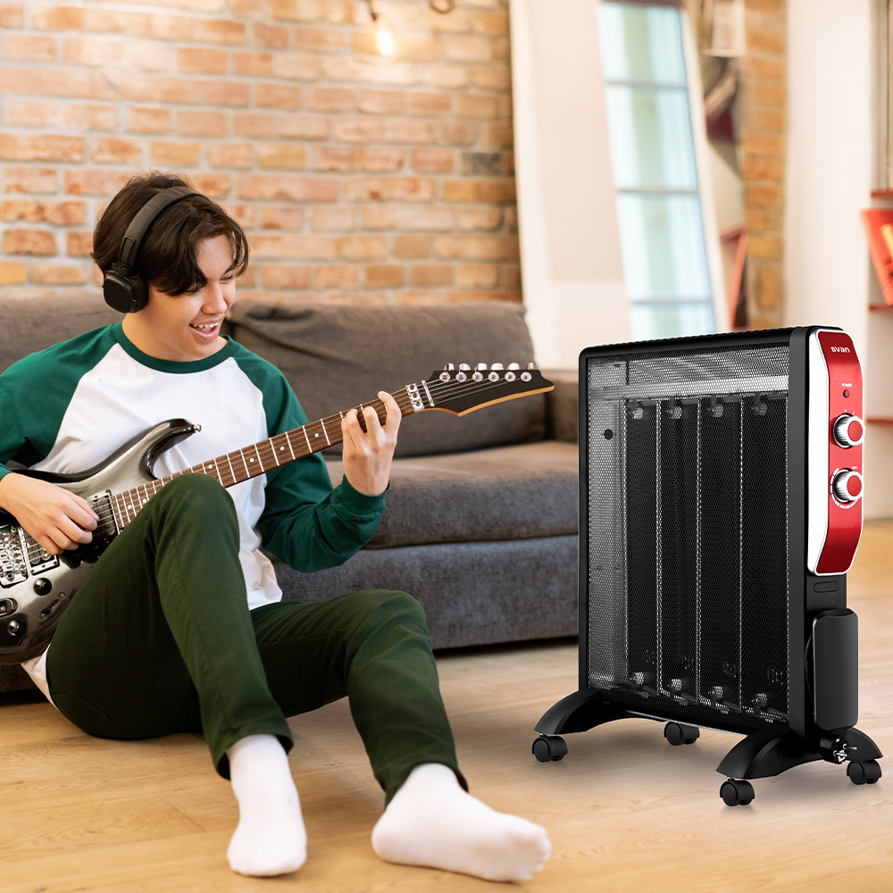Una persona toca la guitarra cerca de un calentador. Calentador negro y rojo.