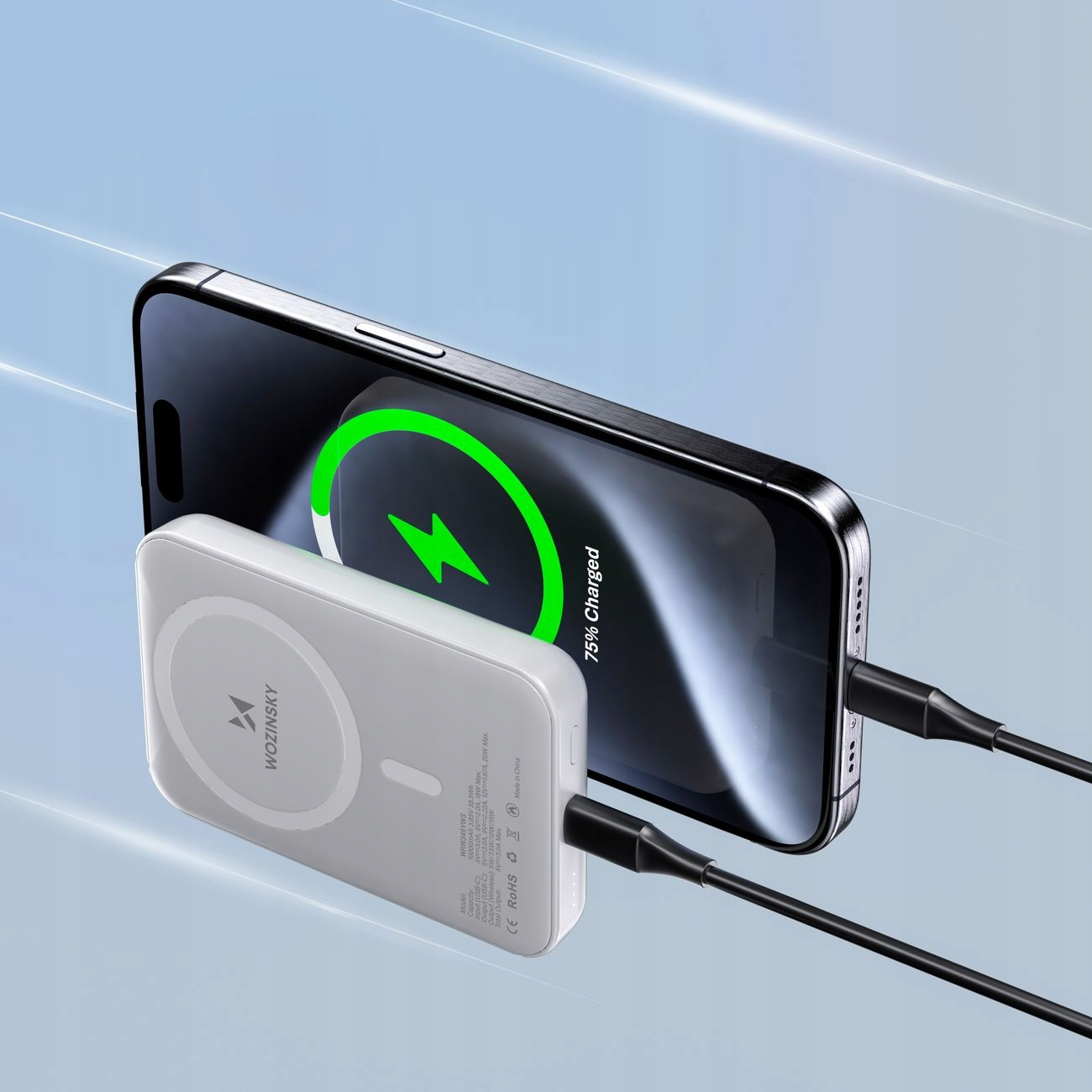 Czarny smartfon ładowany przez biały power bank. Ekran pokazuje 75% naładowania.