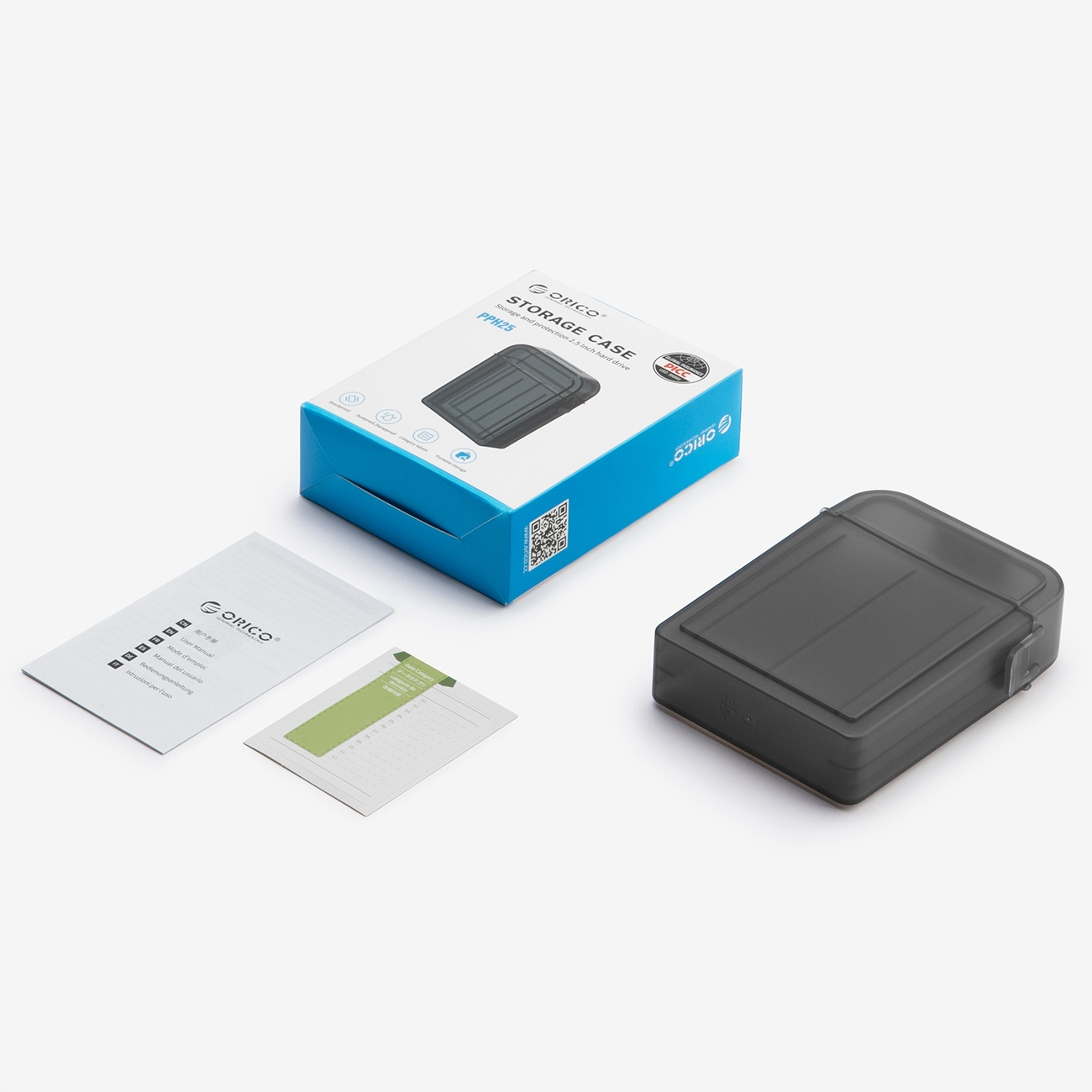 Pudełko do przechowywania z akcesoriami. Obudowa jest szara, a pudełko niebiesko-białe z tekstem.