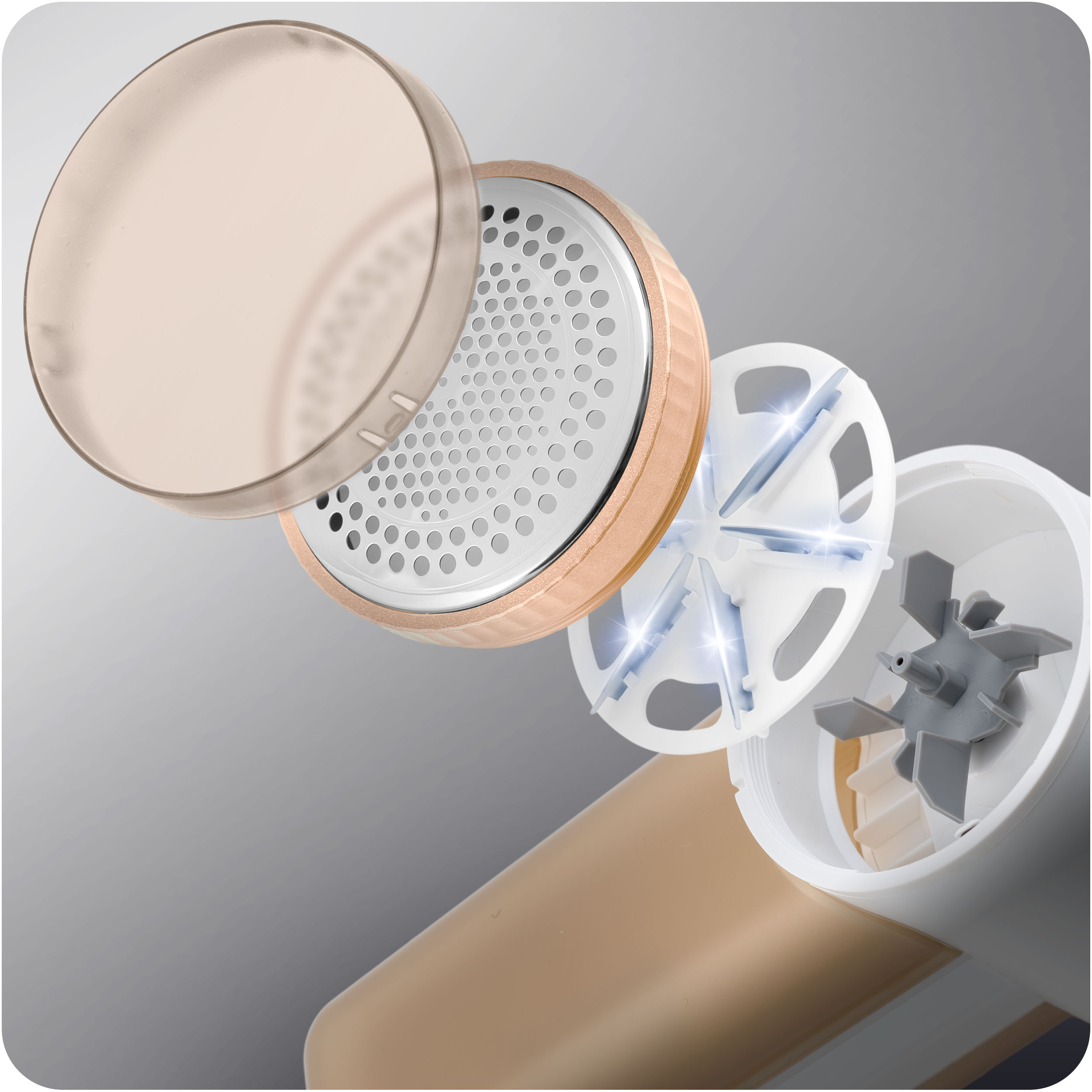 Zbliżenie części golarki do tkanin, w tym ostrza i osłony ochronnej.