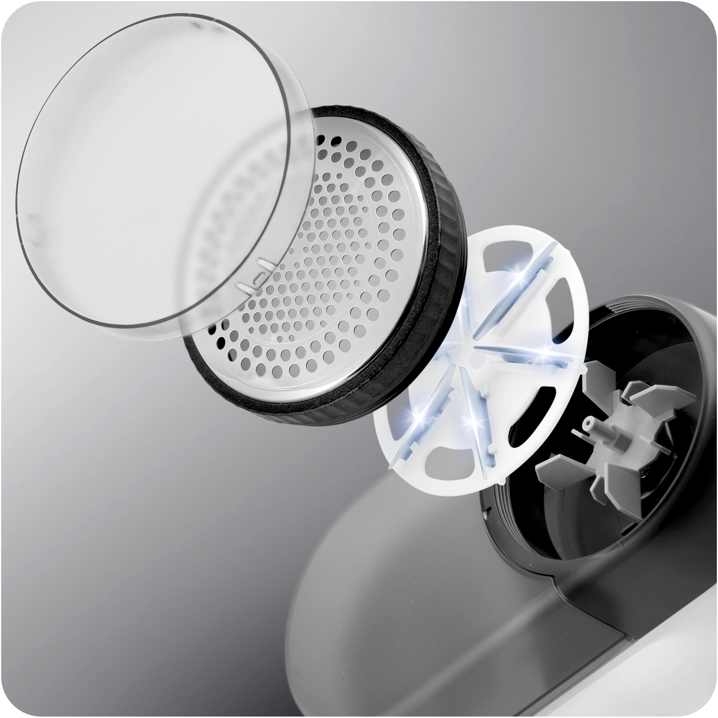 Zdemontowana golarka do tkanin, pokazująca wewnętrzne części. Zawiera ostrze i osłonę.