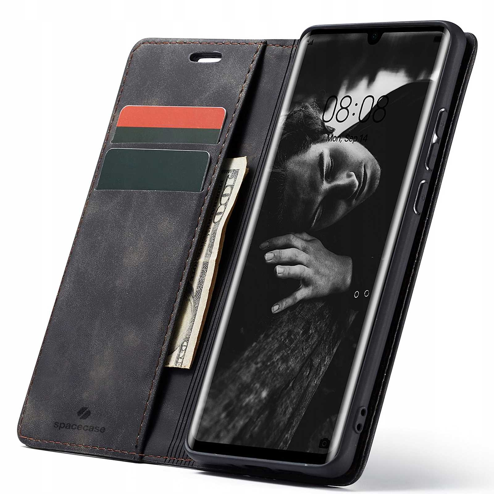 Czarne etui na telefon z telefonem w środku. Etui ma karty i pieniądze. Ekran pokazuje twarz.