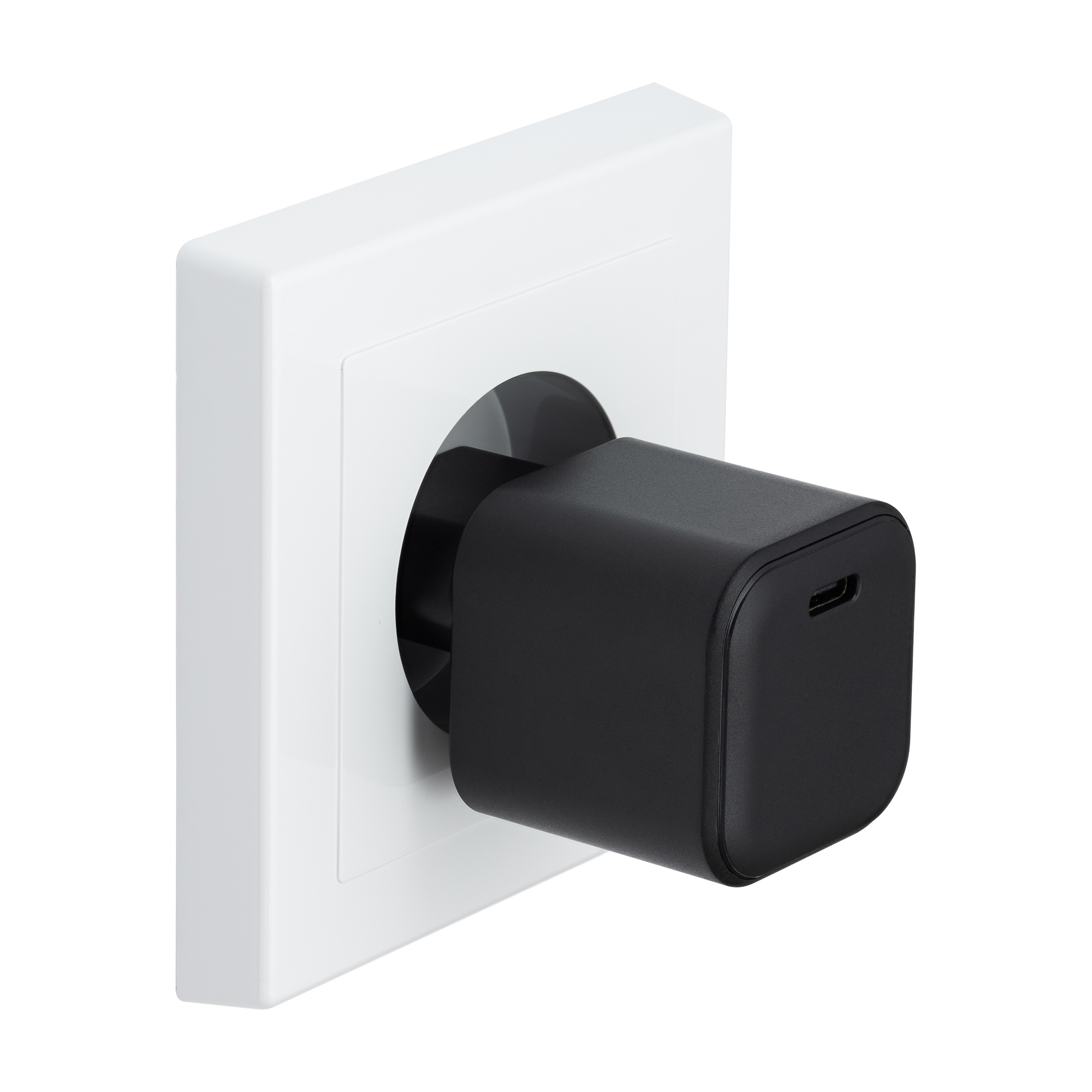 Czarna ładowarka USB włożona do białego gniazdka ściennego.