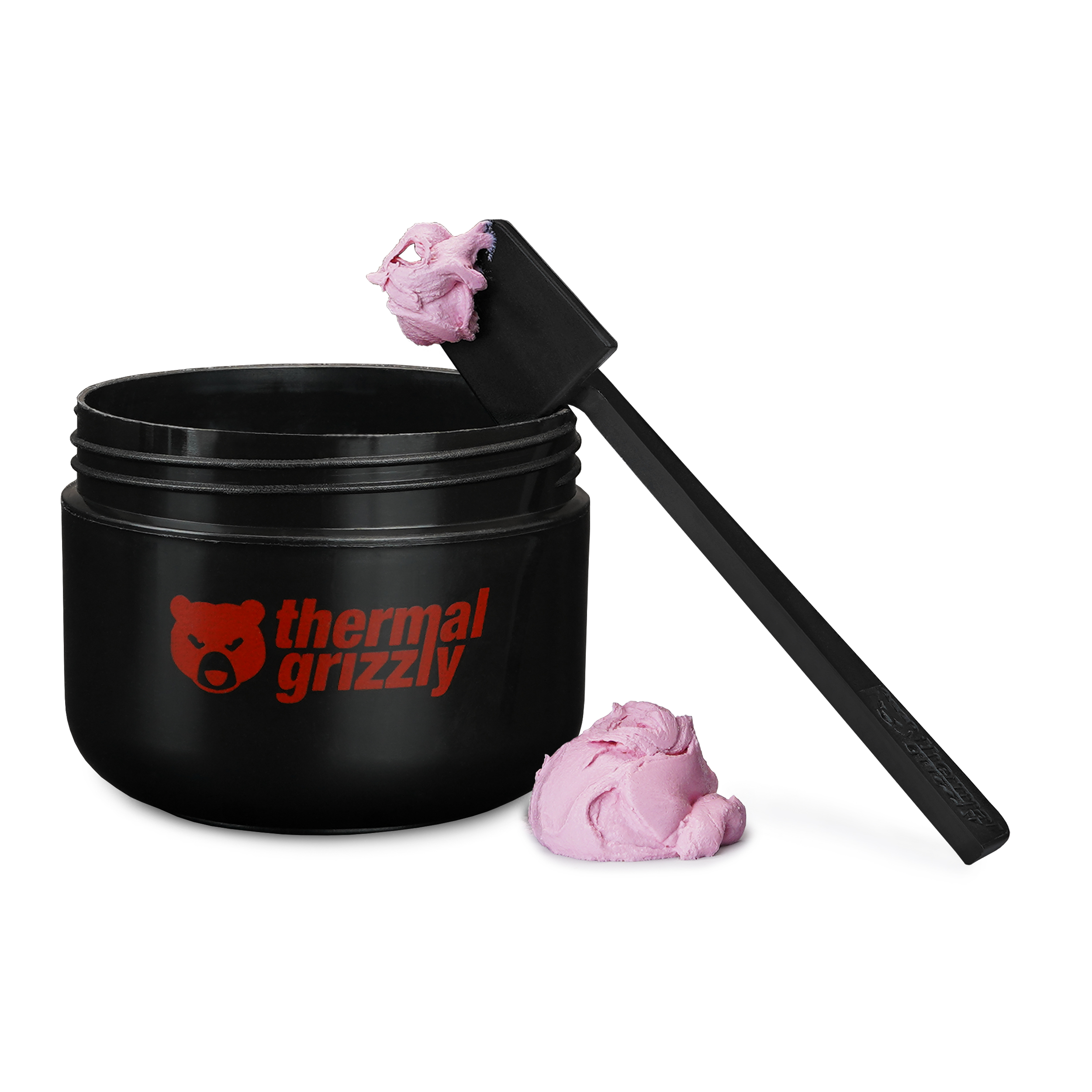 Contenitore nero con pasta termica rosa e una spatola nera.