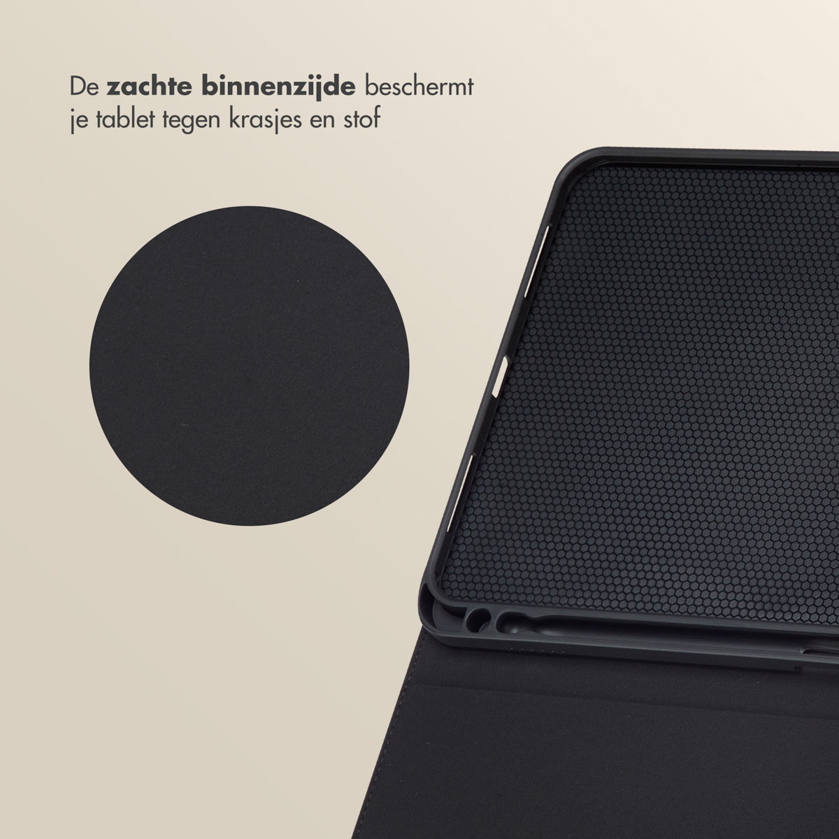 A black tablet case is open, showing a black interior with small holes. A solid black circle is on the left.